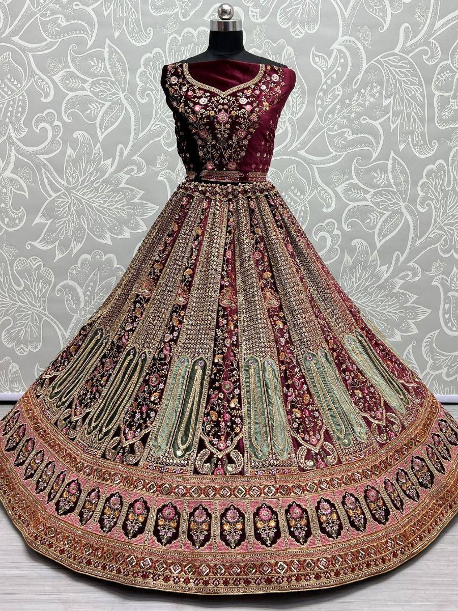 Maroon designer lehenga choli with heavy embroidery and gold detailing, perfect for weddings and festive occasions
