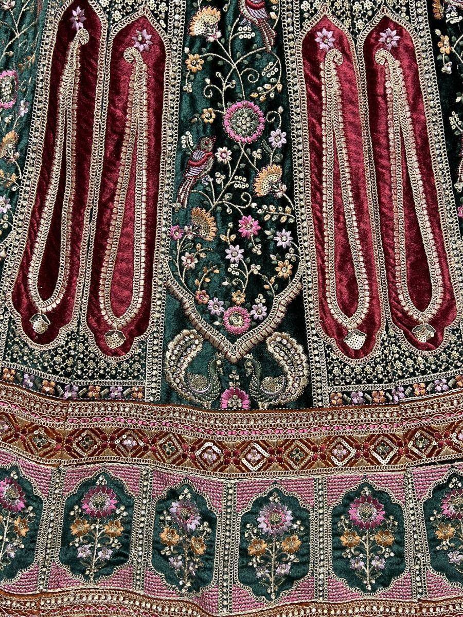 Luxury Indian ethnic wear with intricate floral embroidery, velvet appliqué, and detailed beadwork in maroon and green tones.