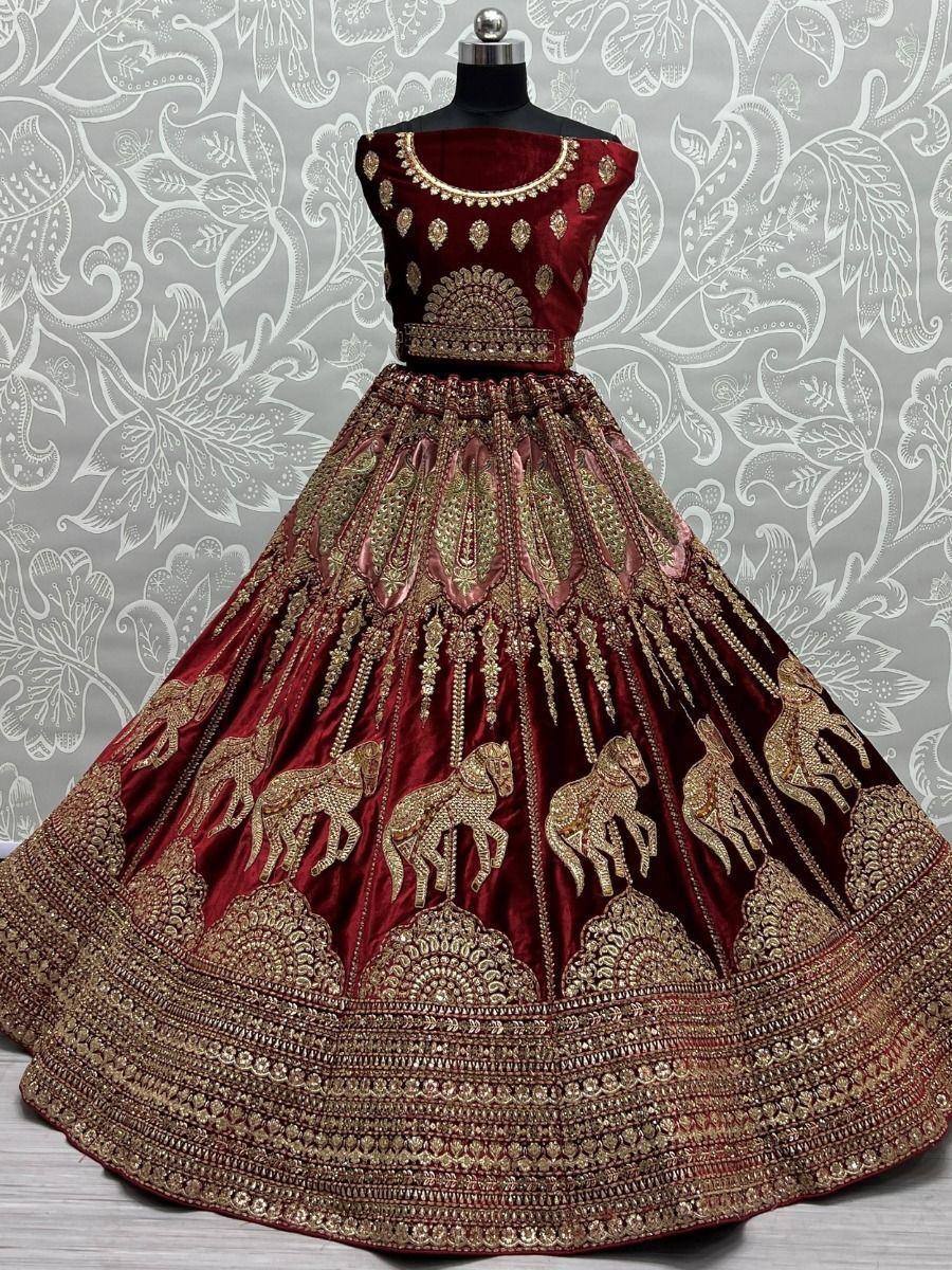 Maroon velvet lehenga choli with gold horse embroidery and heavy zari work, perfect for weddings and festivals