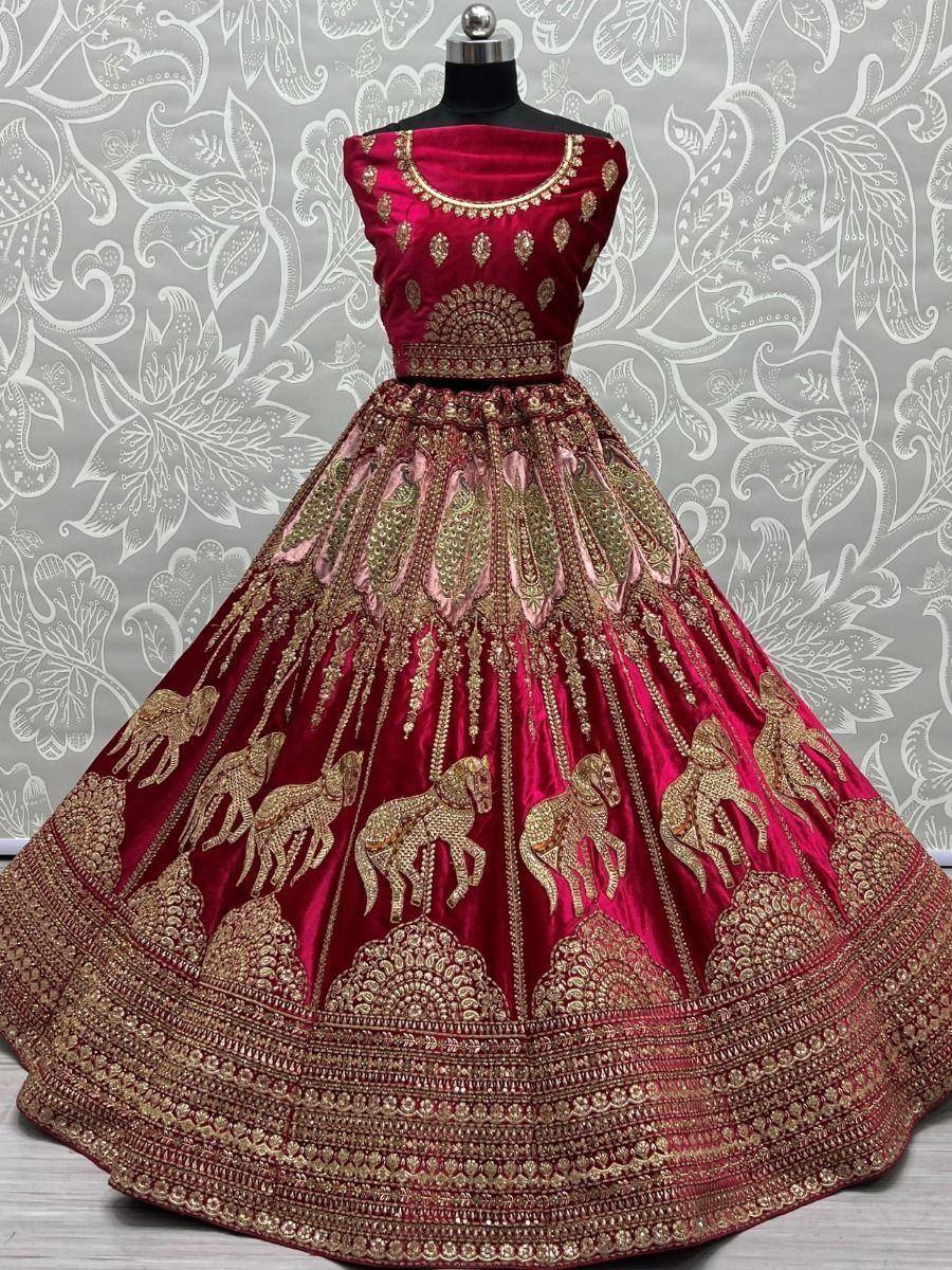 Red velvet lehenga choli with gold horse embroidery and intricate border, perfect for Indian weddings and festive occasions.