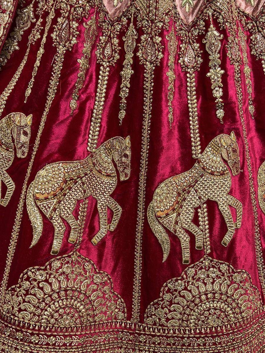 Rich maroon velvet lehenga with golden horse embroidery and intricate zari work, perfect for Indian ethnic wear.