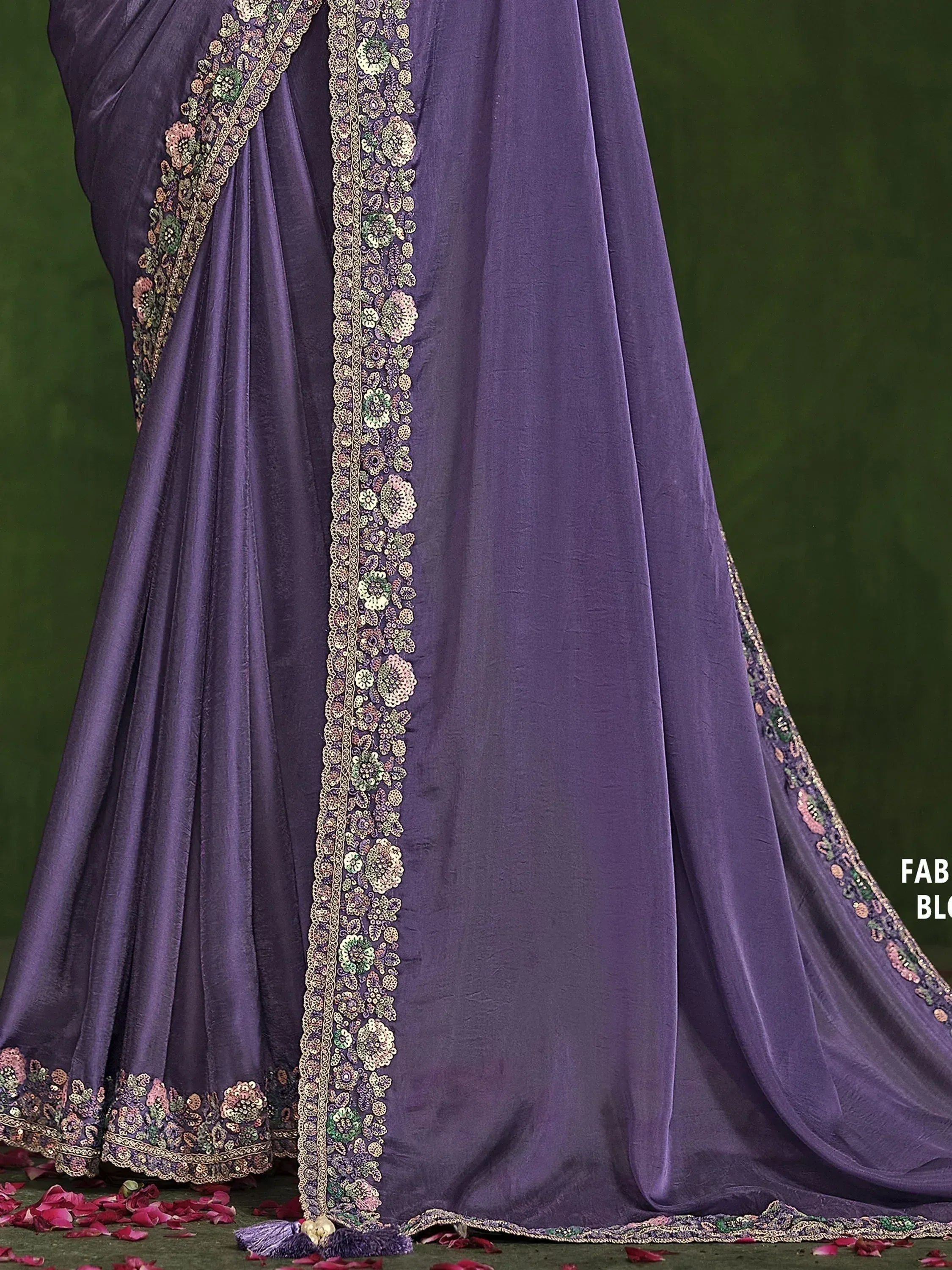 Purple designer saree with floral embroidery and tassels, ideal for Indian ethnic wear occasions.