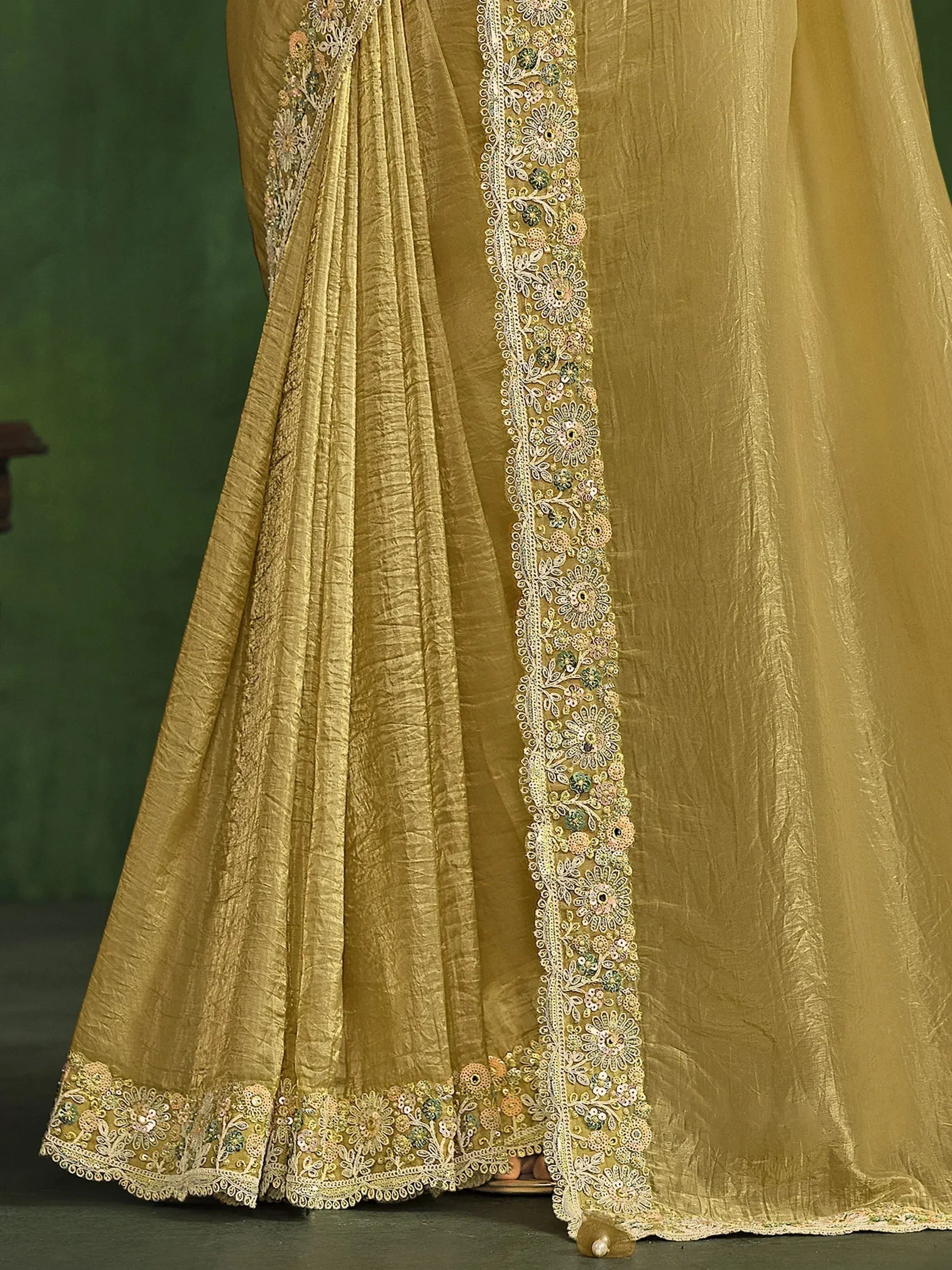 Golden ethnic saree with floral embroidery and sequin detailing, perfect for Indian weddings and festive occasions.