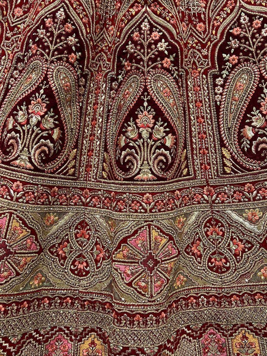 Richly embroidered maroon ethnic wear with floral and paisley motifs, perfect for designer lehenga or saree