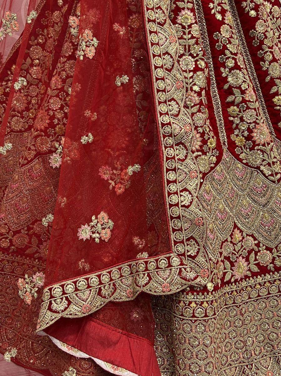 Red velvet lehenga choli with gold floral embroidery and intricate border detailing