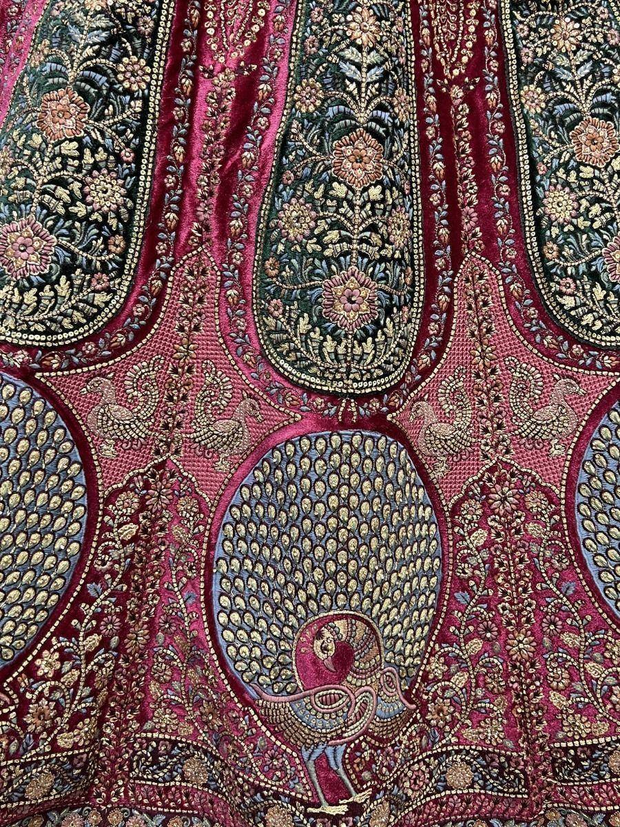 Luxury Indian ethnic wear with intricate peacock and floral embroidery on rich velvet fabric
