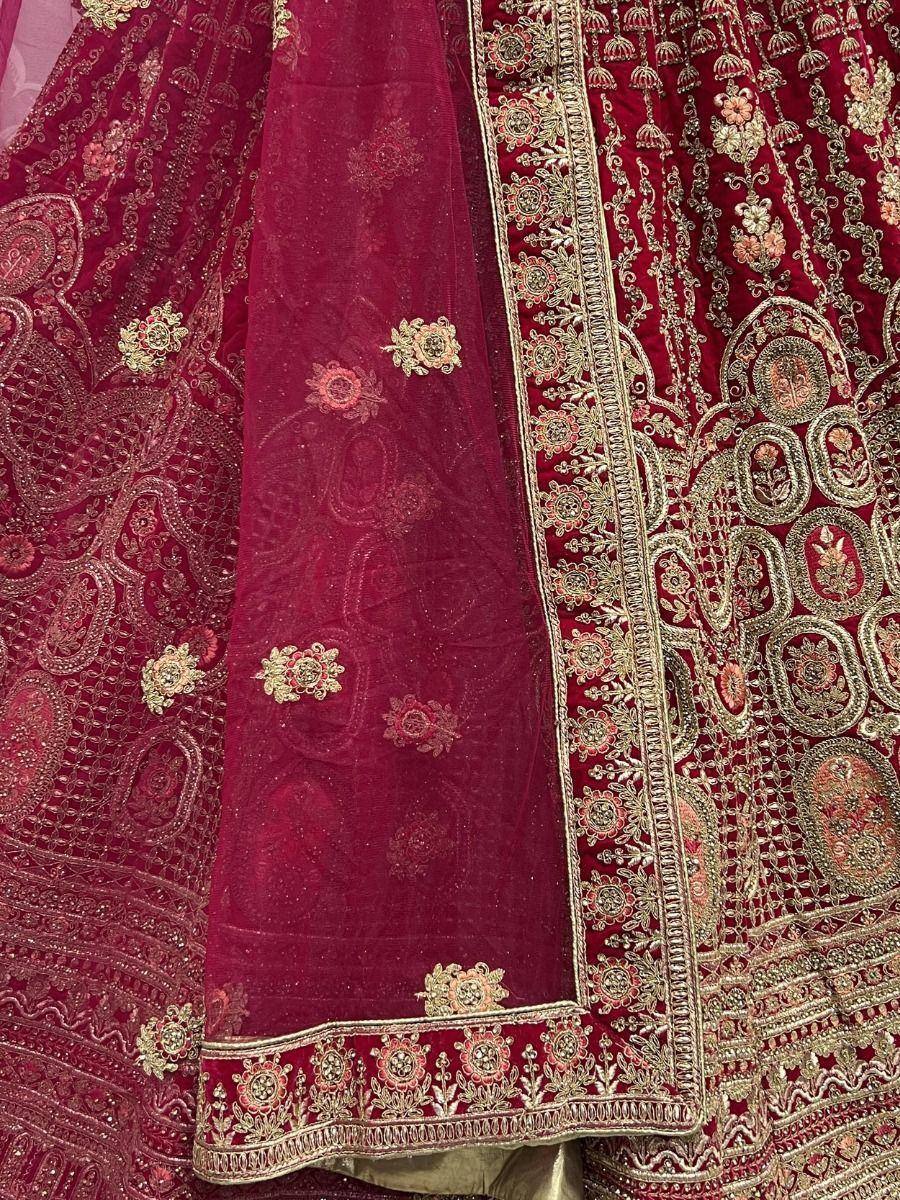 Rich maroon lehenga choli with intricate gold embroidery and floral motifs, perfect for Indian ethnic wear.