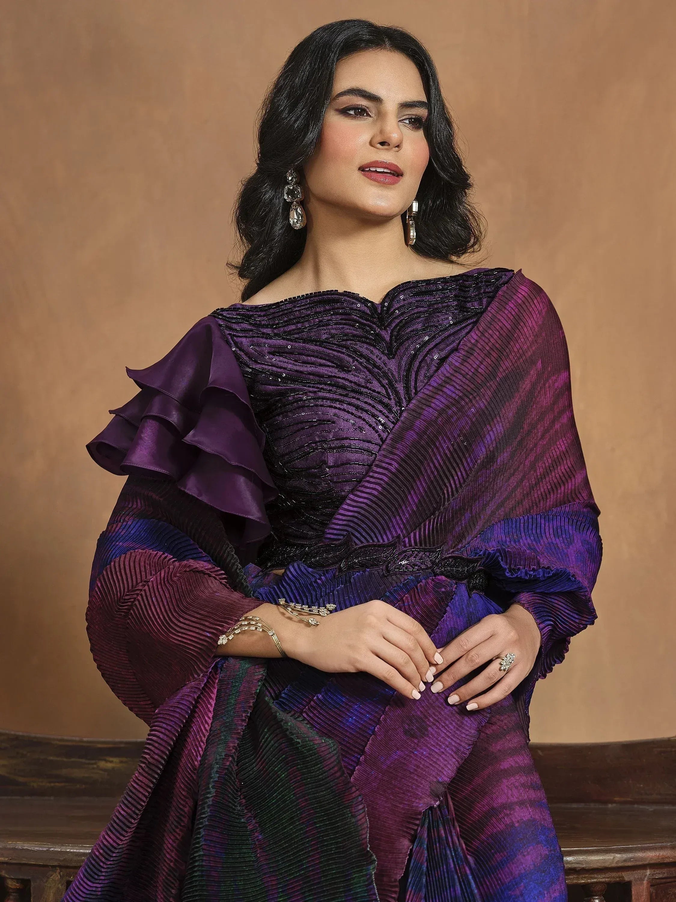Elegant purple ethnic gown with ruffle sleeves and sequin detailing, perfect for Indian festive occasions.