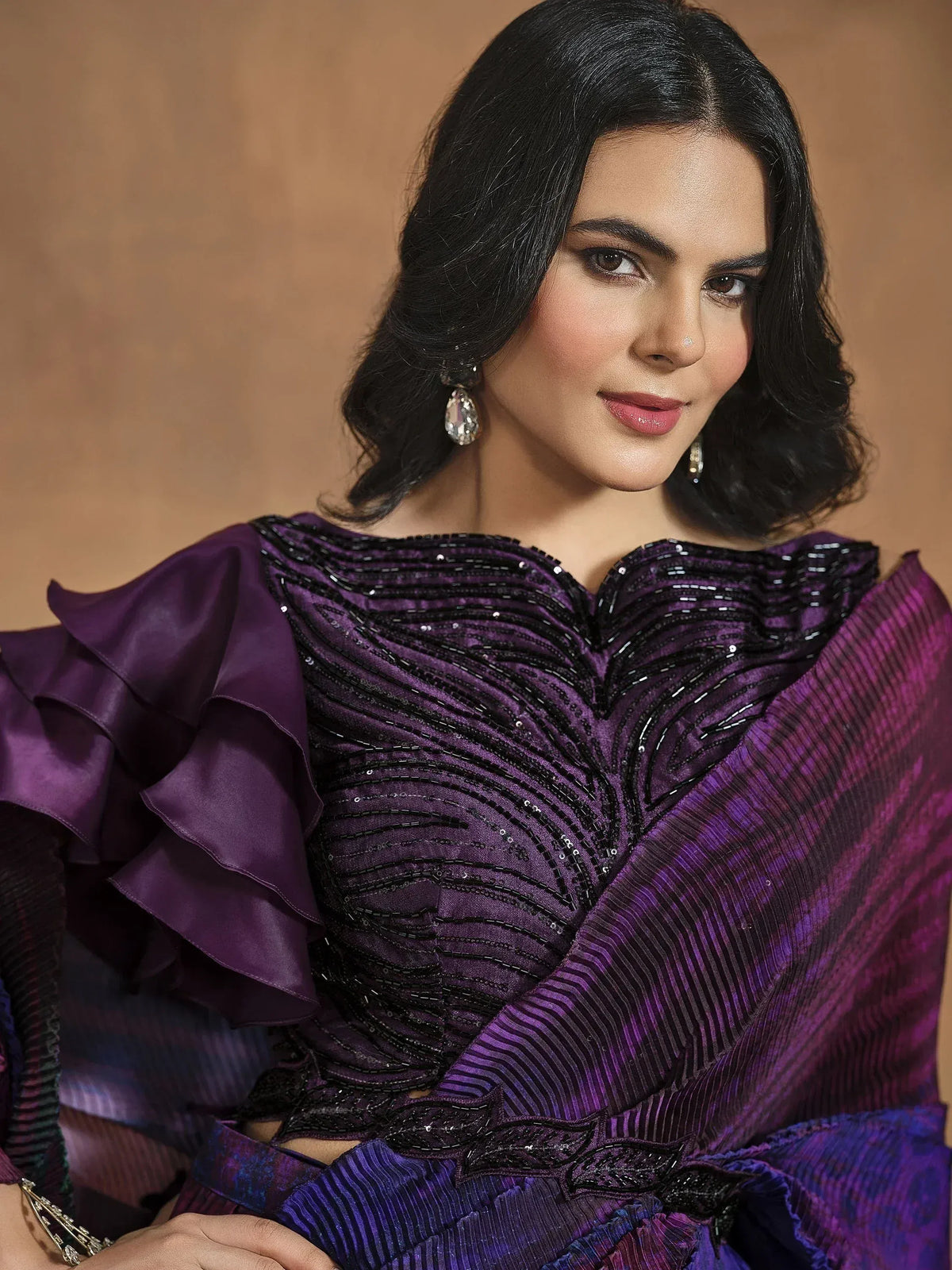 Purple ethnic gown with black beadwork, ruffled sleeves, and pleated dupatta for festive occasions