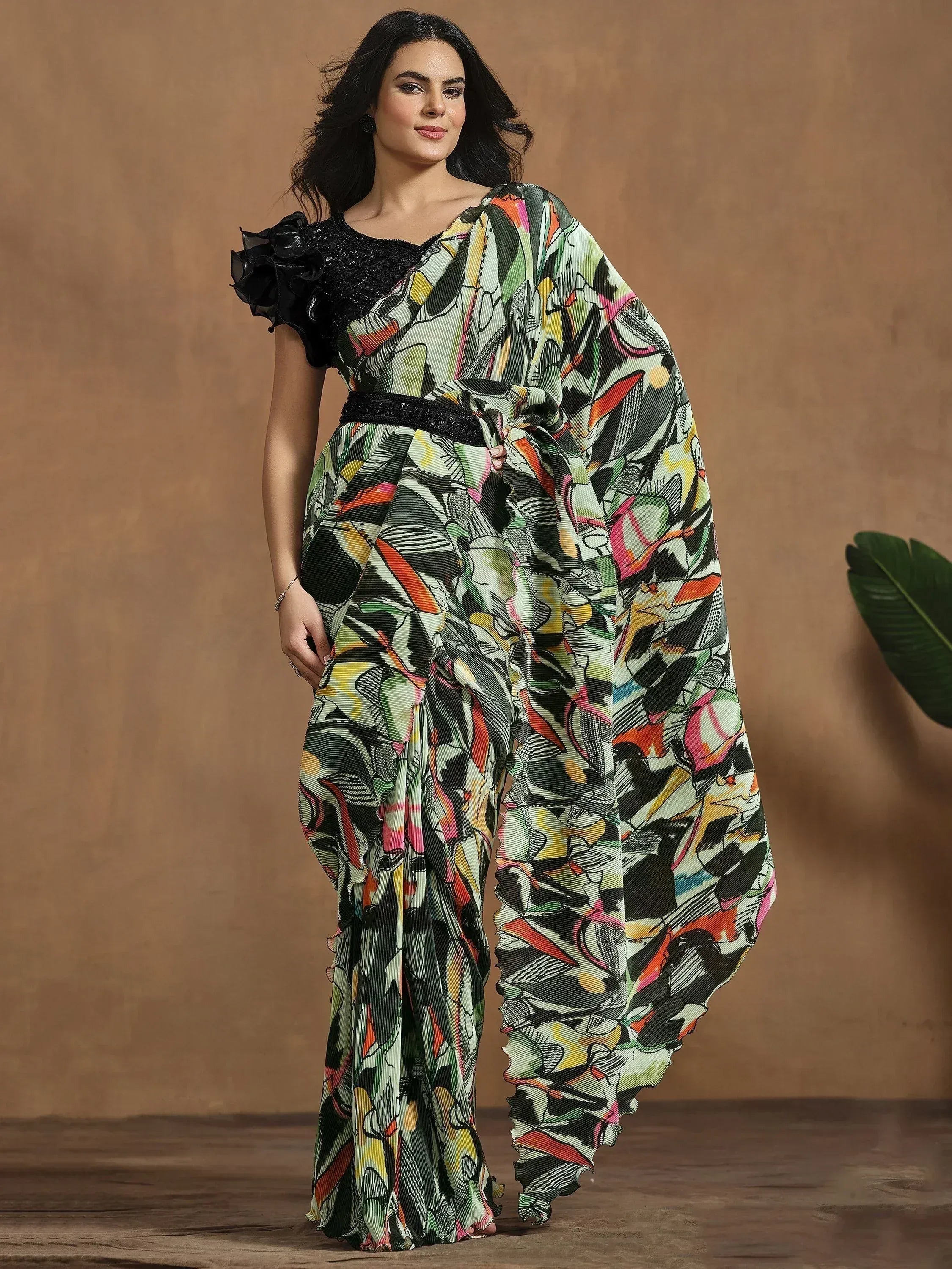 Woman in colorful printed saree with black ruffle blouse, ethnic Indian wear