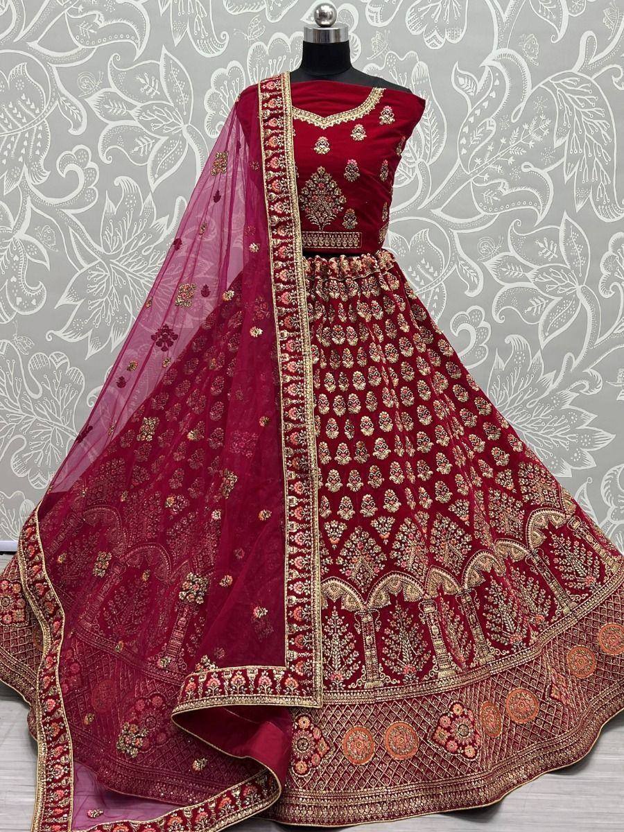 Maroon designer lehenga choli with gold embroidery and matching dupatta, ideal for Indian weddings and festive occasions.