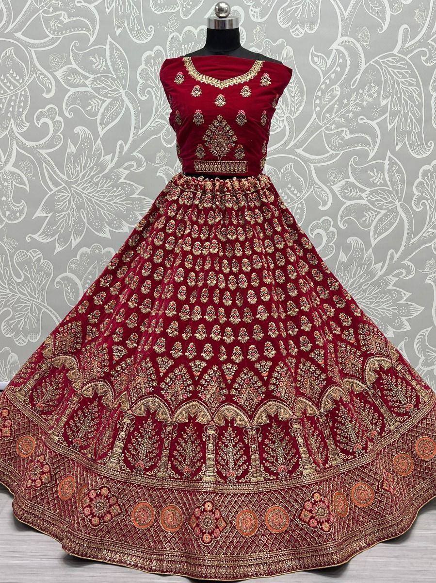 Maroon velvet lehenga choli with gold embroidery, perfect for Indian weddings and festive occasions.