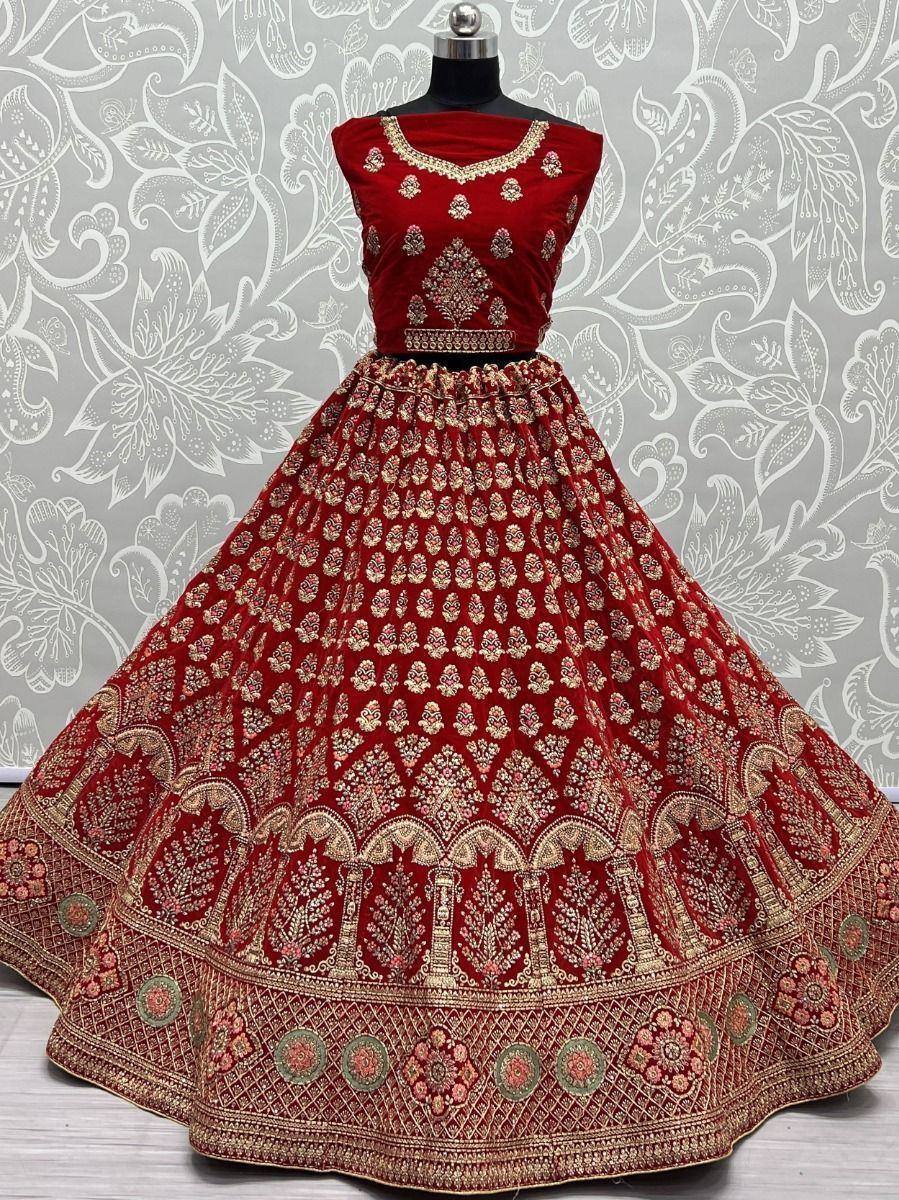 Red velvet lehenga choli with gold embroidery, perfect for Indian weddings and festive occasions