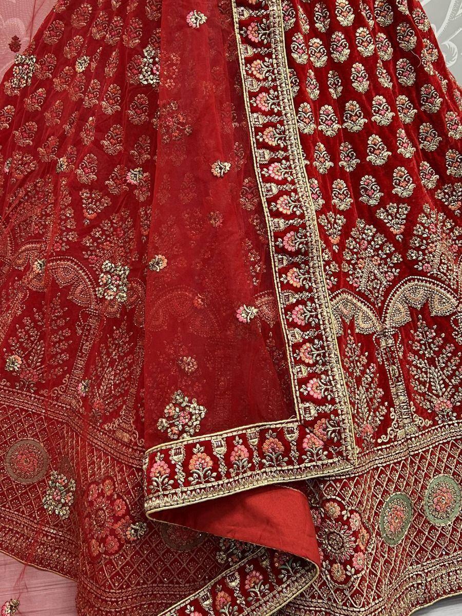 Red velvet lehenga choli with intricate gold and floral embroidery, perfect for Indian weddings and ethnic occasions.