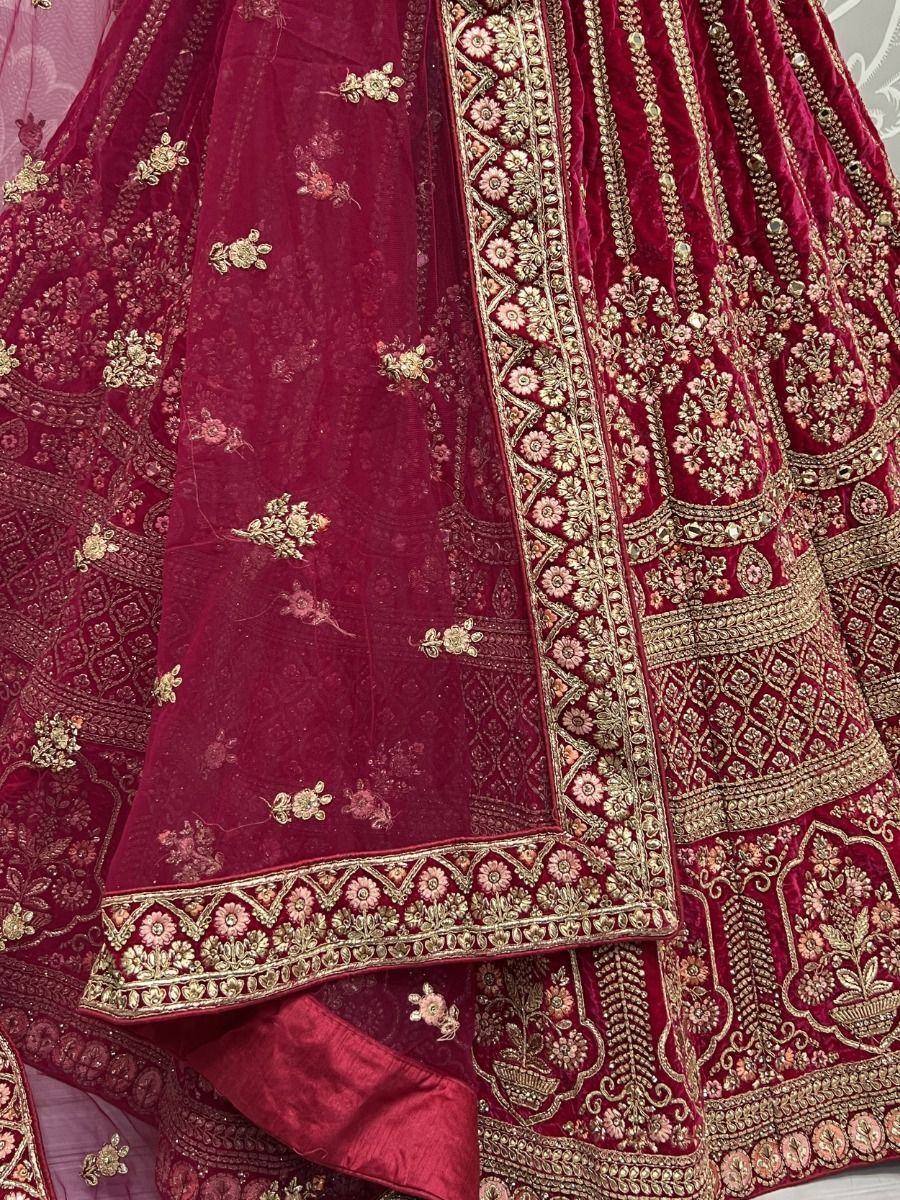 Luxury maroon velvet lehenga choli with gold floral embroidery and net dupatta, perfect for Indian weddings