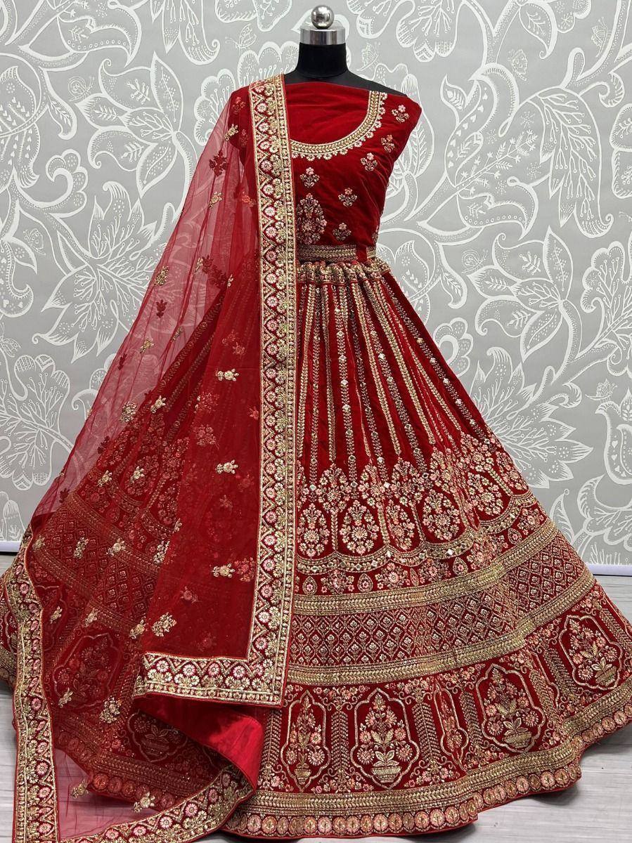 Red velvet designer lehenga choli with gold embroidery and matching dupatta, ideal for weddings and festive occasions