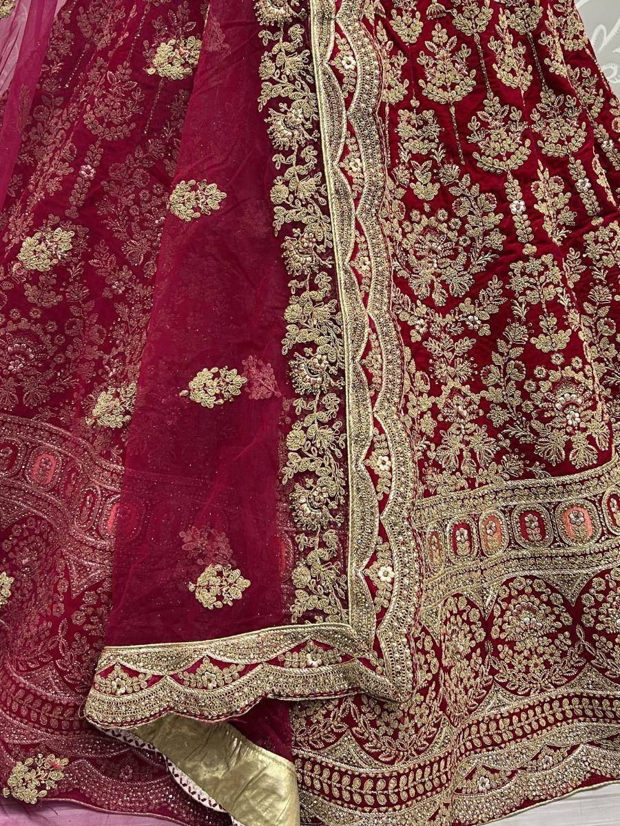 Luxury maroon velvet lehenga with intricate gold embroidery and detailed border work