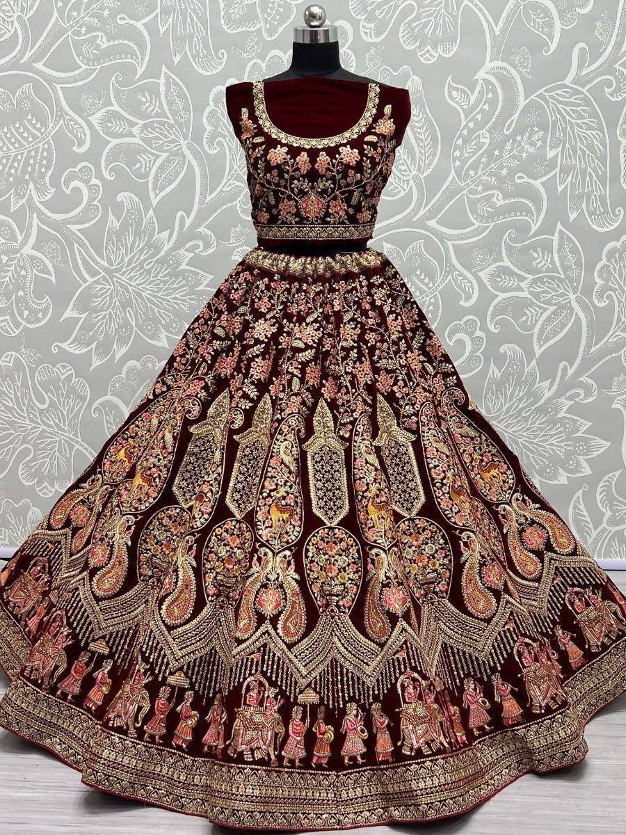 Maroon velvet lehenga choli with intricate gold embroidery and peacock motifs, perfect for Indian weddings and festive occasions.