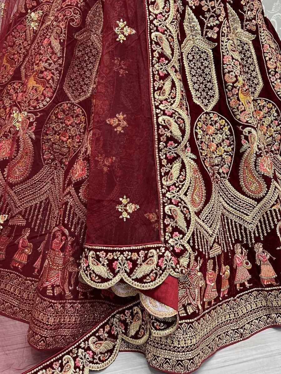 Maroon velvet lehenga with intricate gold embroidery, peacock and deer motifs, perfect for Indian weddings