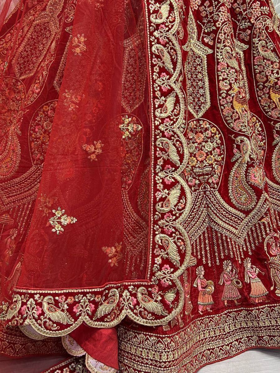 Red velvet lehenga with gold paisley and floral embroidery, perfect for Indian weddings and festive occasions