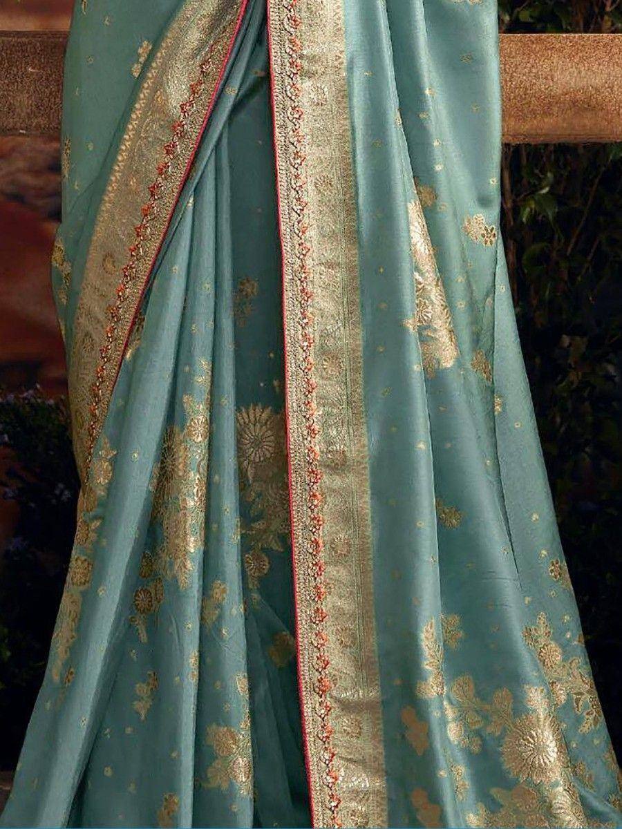 Teal blue saree with gold floral embroidery and ornate border, ideal for Indian ethnic occasions