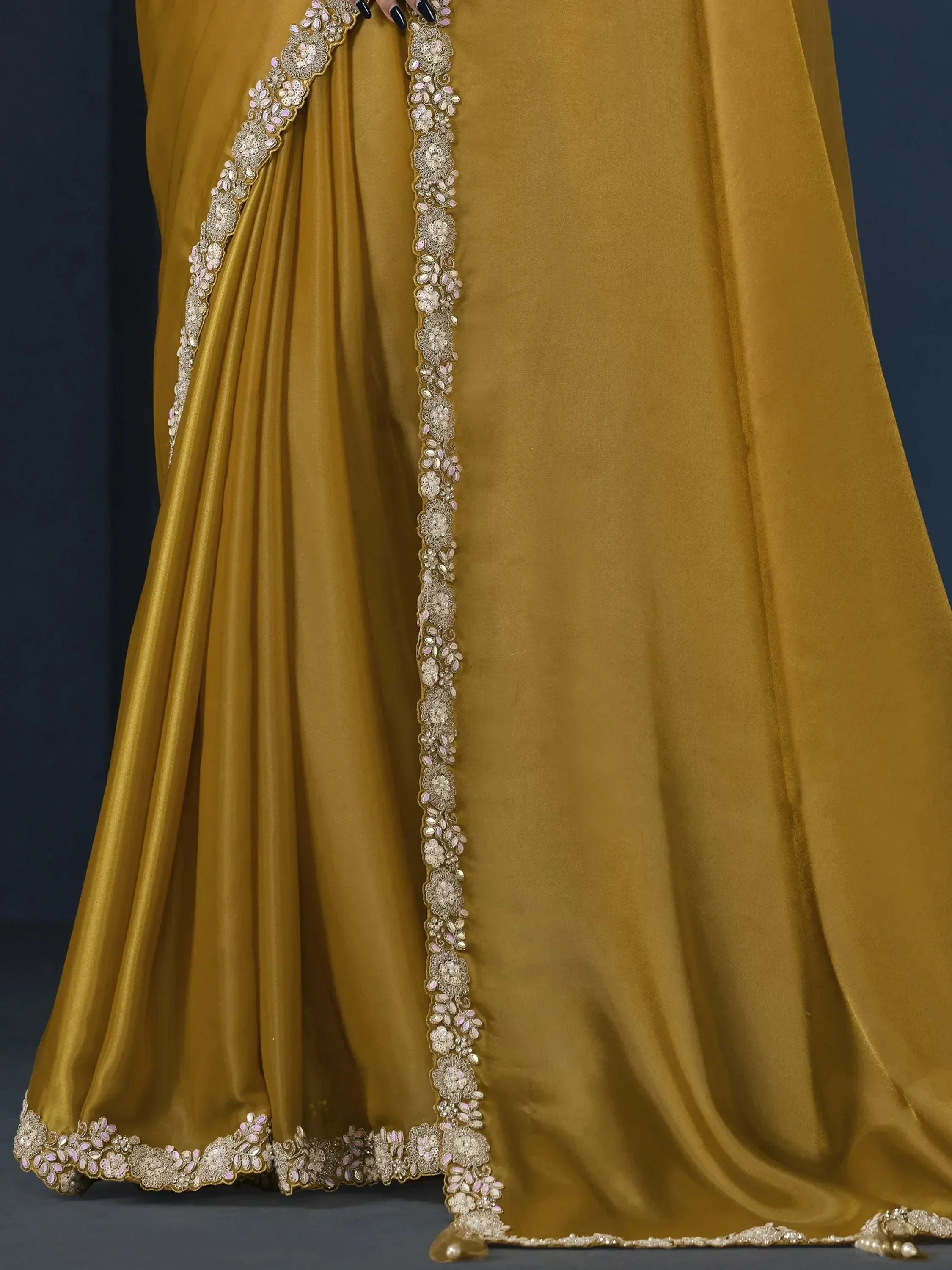 Mustard yellow ethnic gown with intricate floral embroidery and sequin detailing for festive occasions