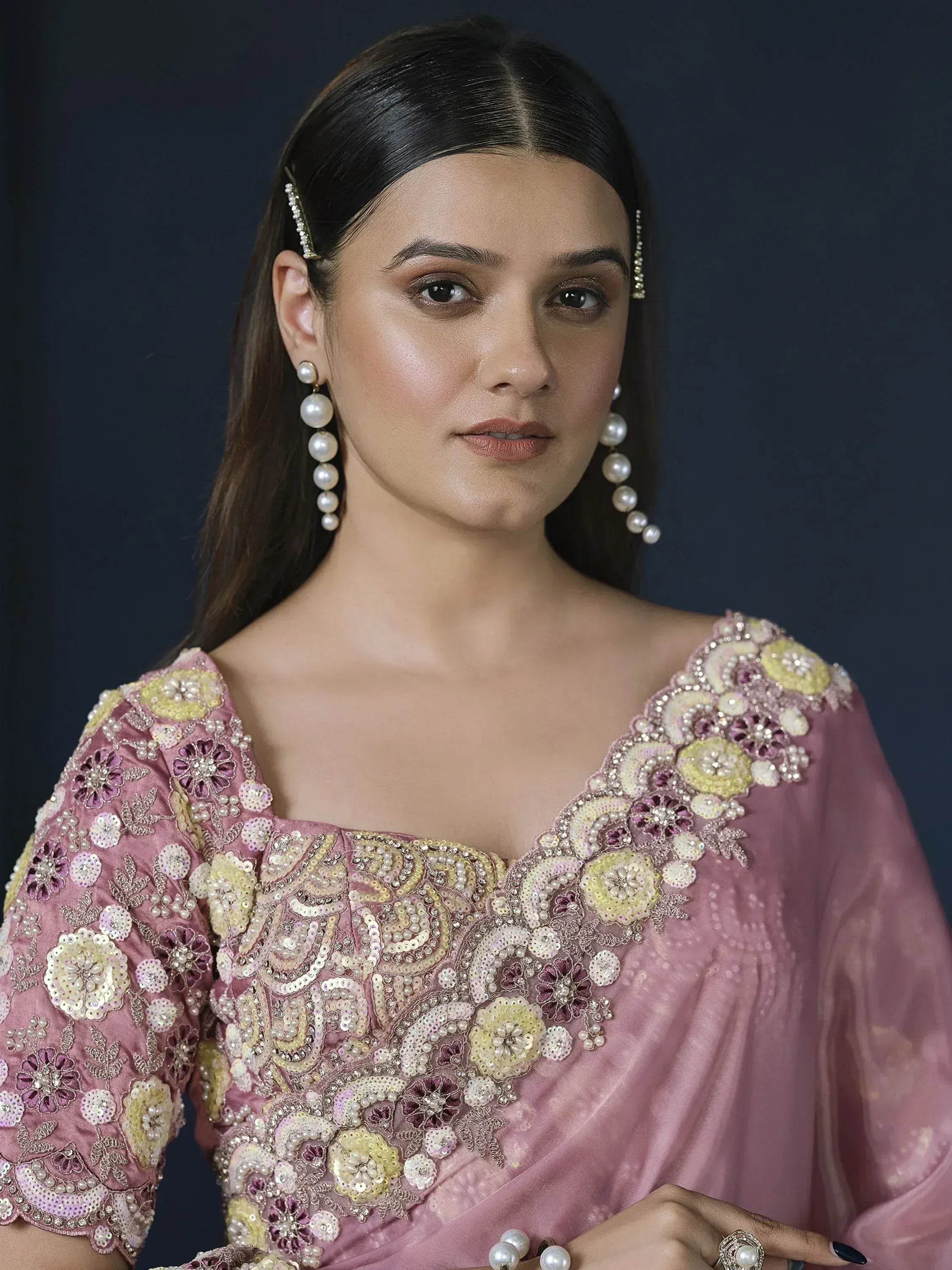 Elegant pink ethnic gown with floral embroidery and pearl jewelry for Indian occasions