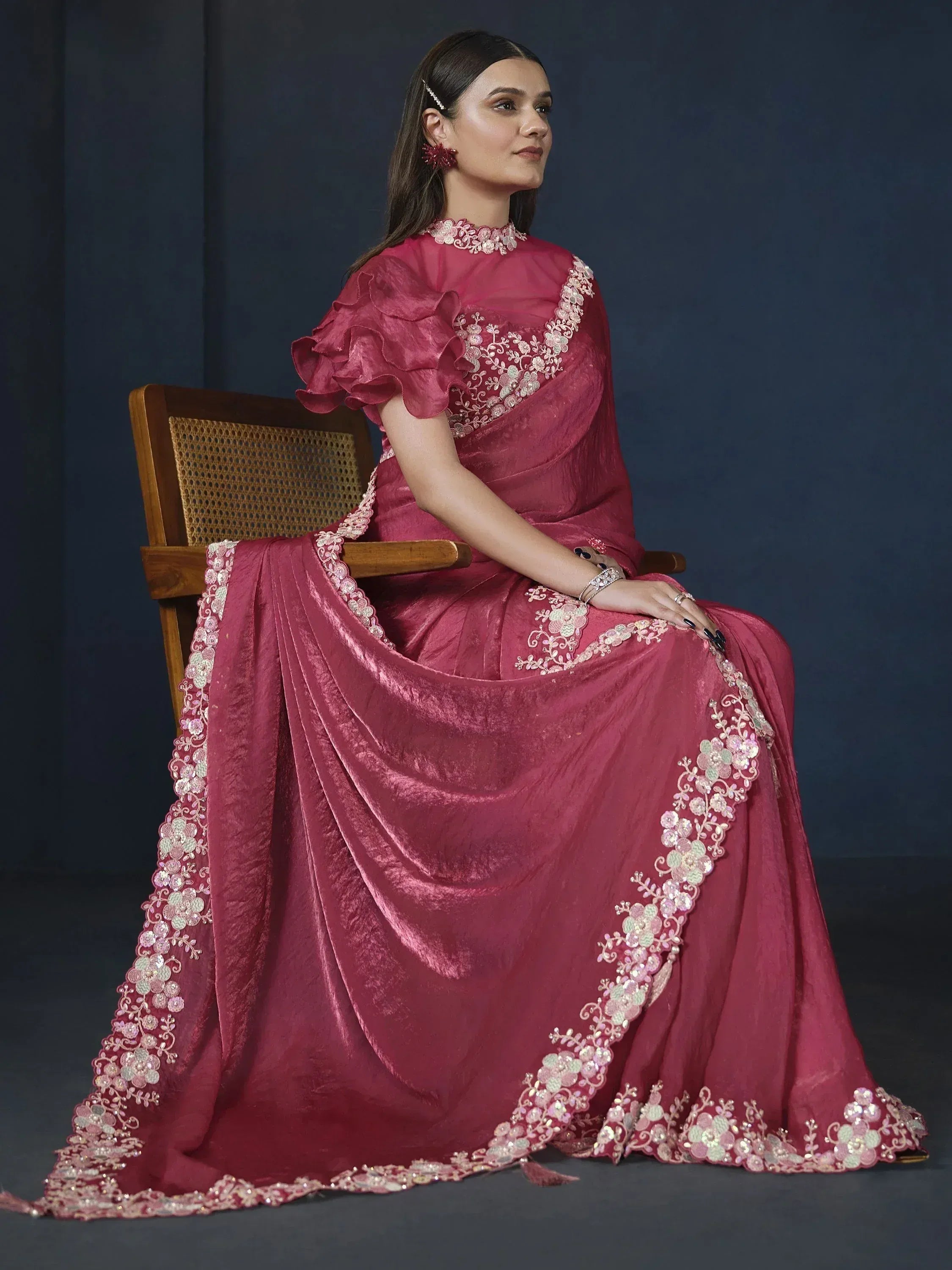 Elegant maroon ethnic gown with floral embroidery and ruffled sleeves, perfect for Indian weddings or festive occasions.