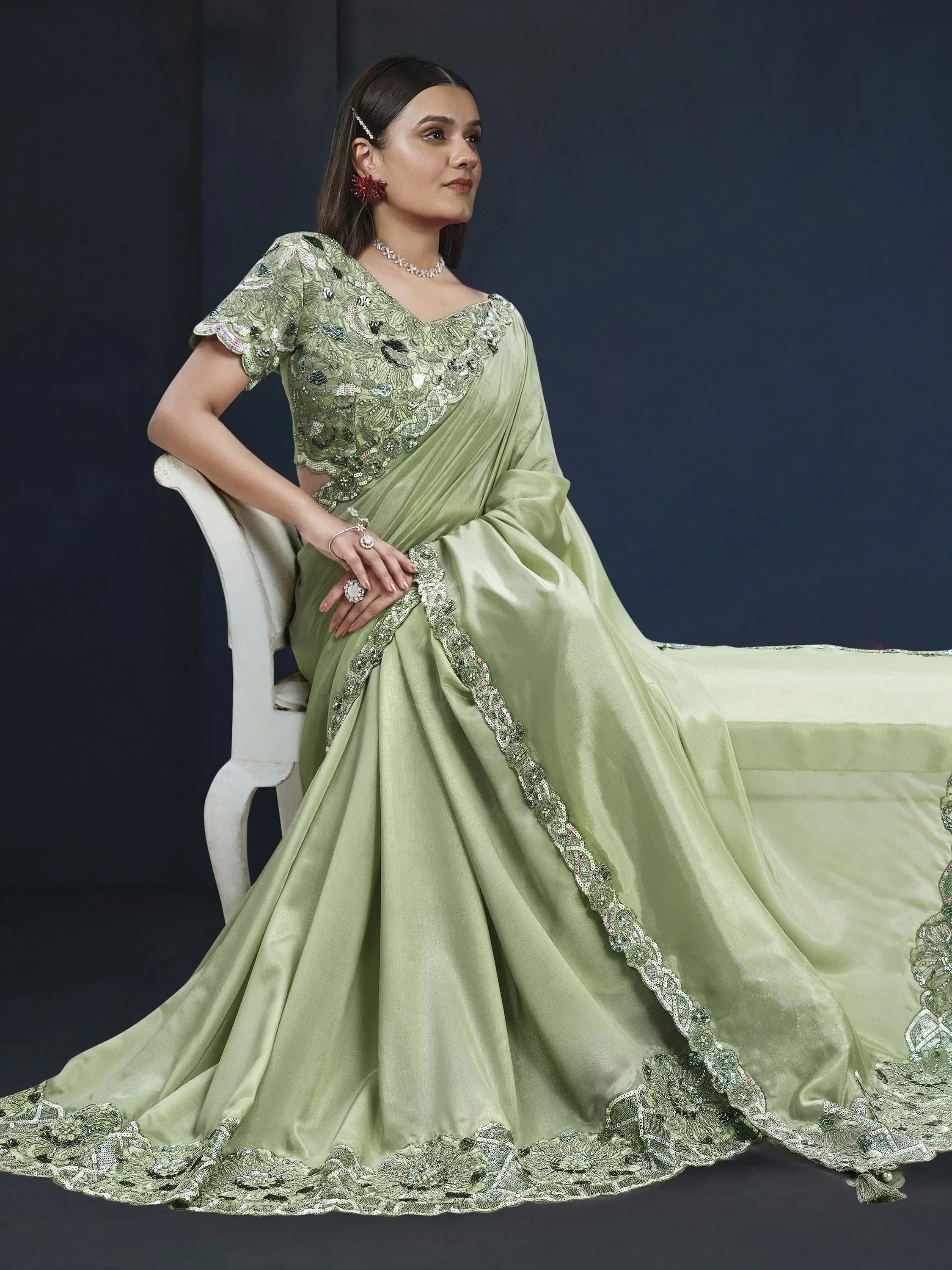 Elegant light green saree with heavy embroidery and sequin work, perfect for Indian ethnic occasions.