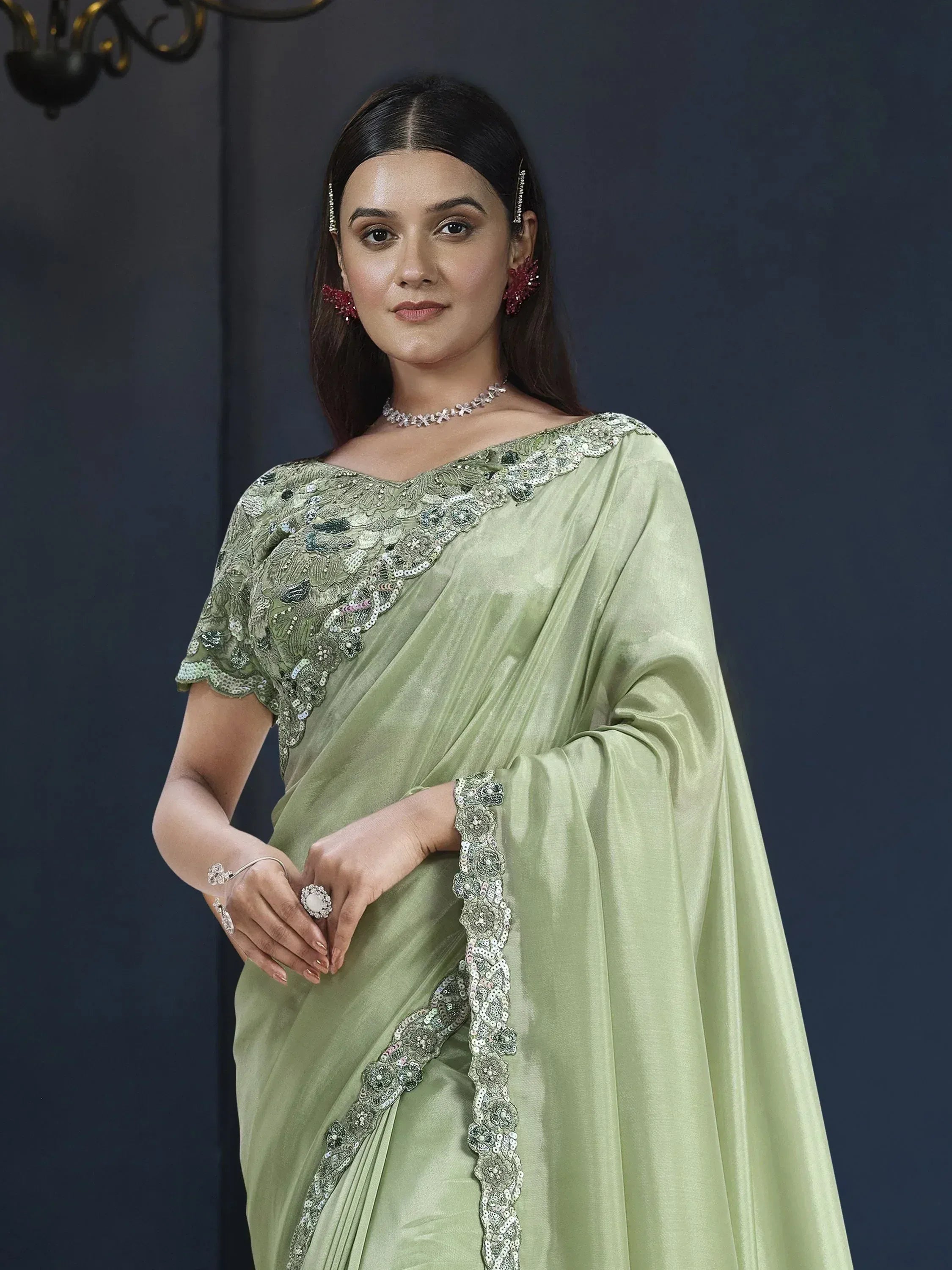 Elegant light green saree with intricate sequin embroidery, perfect for Indian ethnic occasions