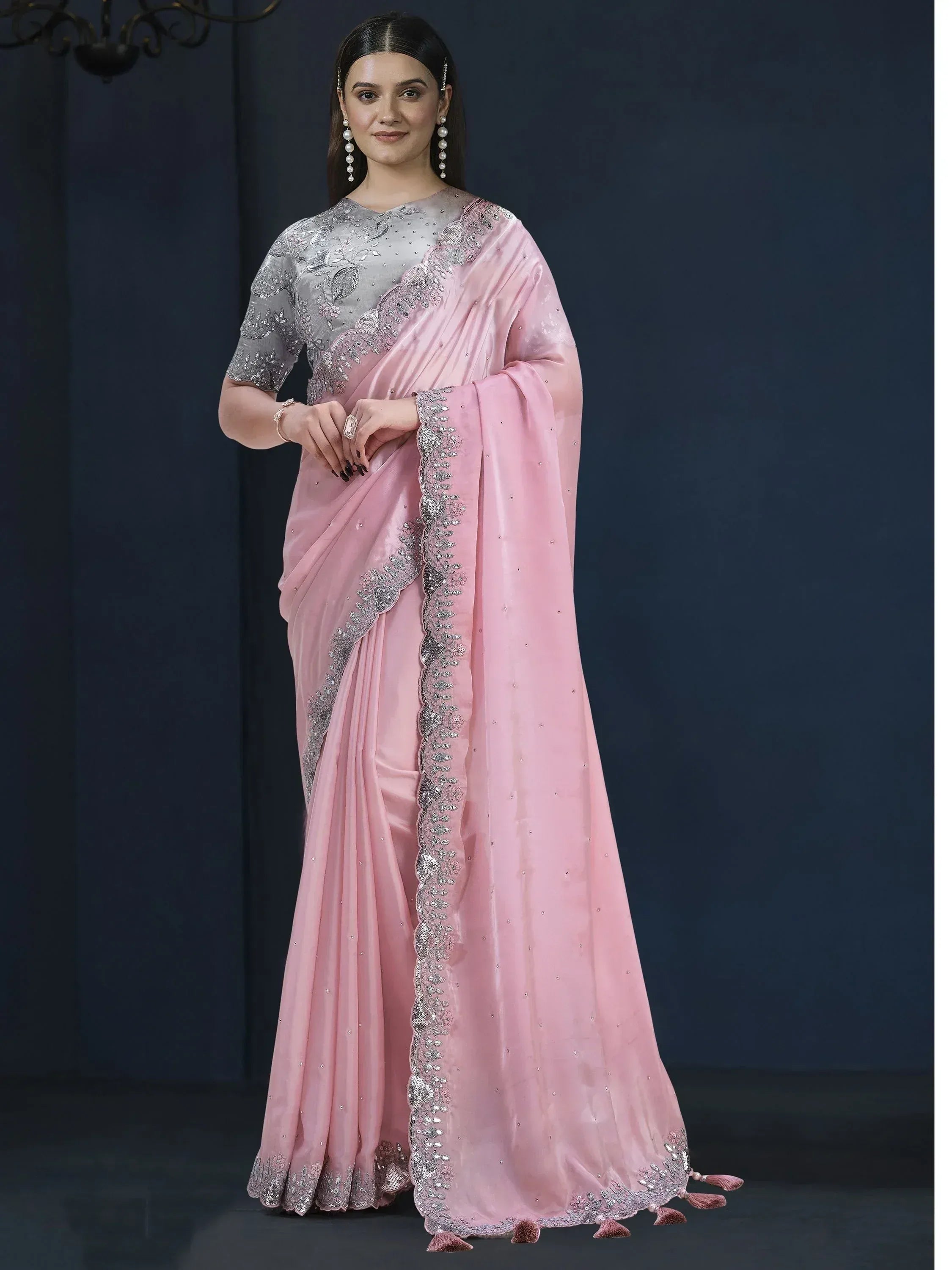 Pink saree with silver embroidery and tassels, paired with a grey blouse for Indian ethnic wear