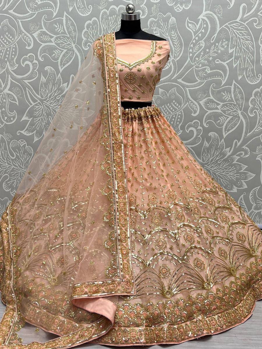 Pink designer lehenga choli with gold embroidery and net dupatta, perfect for Indian weddings and festive occasions