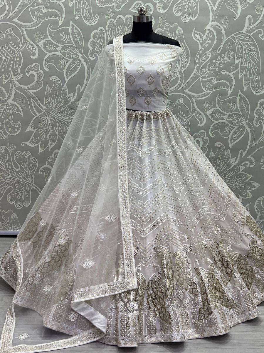 White and gold embroidered lehenga choli with peacock motifs and sheer dupatta, perfect for Indian weddings