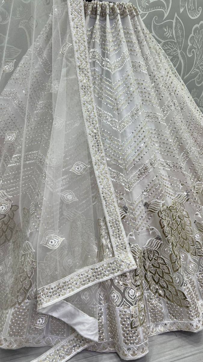 White embroidered lehenga choli with peacock motifs and sequin detailing, ideal for Indian ethnic wear