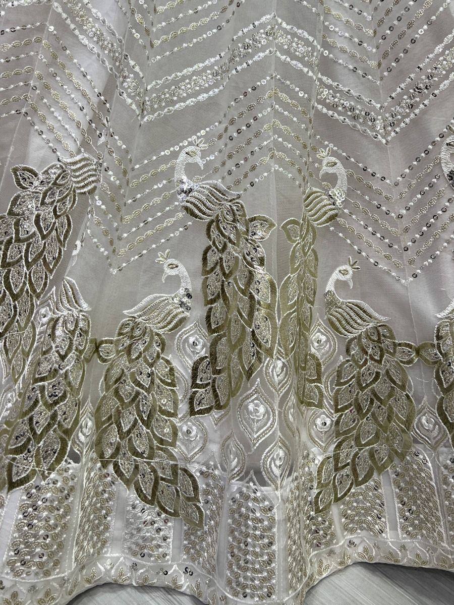 Elegant white lehenga with peacock embroidery and sequin detailing for Indian ethnic wear