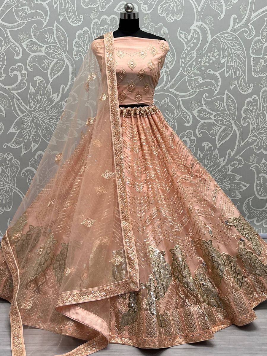 Pink designer lehenga choli with gold embroidery and peacock motifs, perfect for Indian weddings and festive occasions