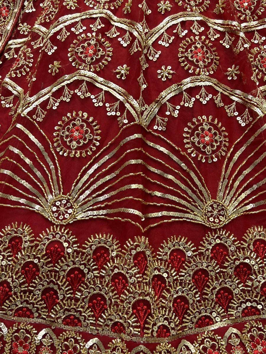 Rich red ethnic wear with gold sequin embroidery and floral motifs, perfect for festive occasions.