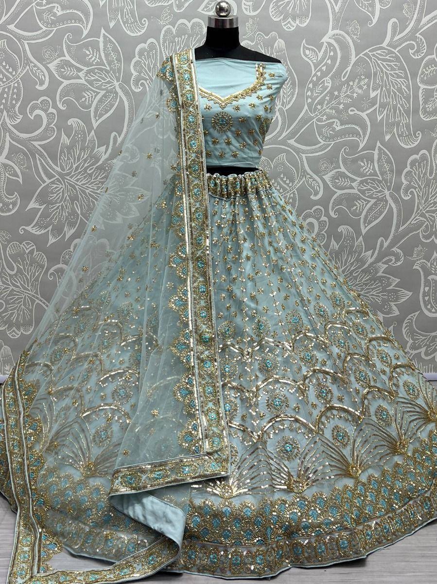 Light blue designer lehenga choli with gold and turquoise embroidery, perfect for weddings and festive occasions.