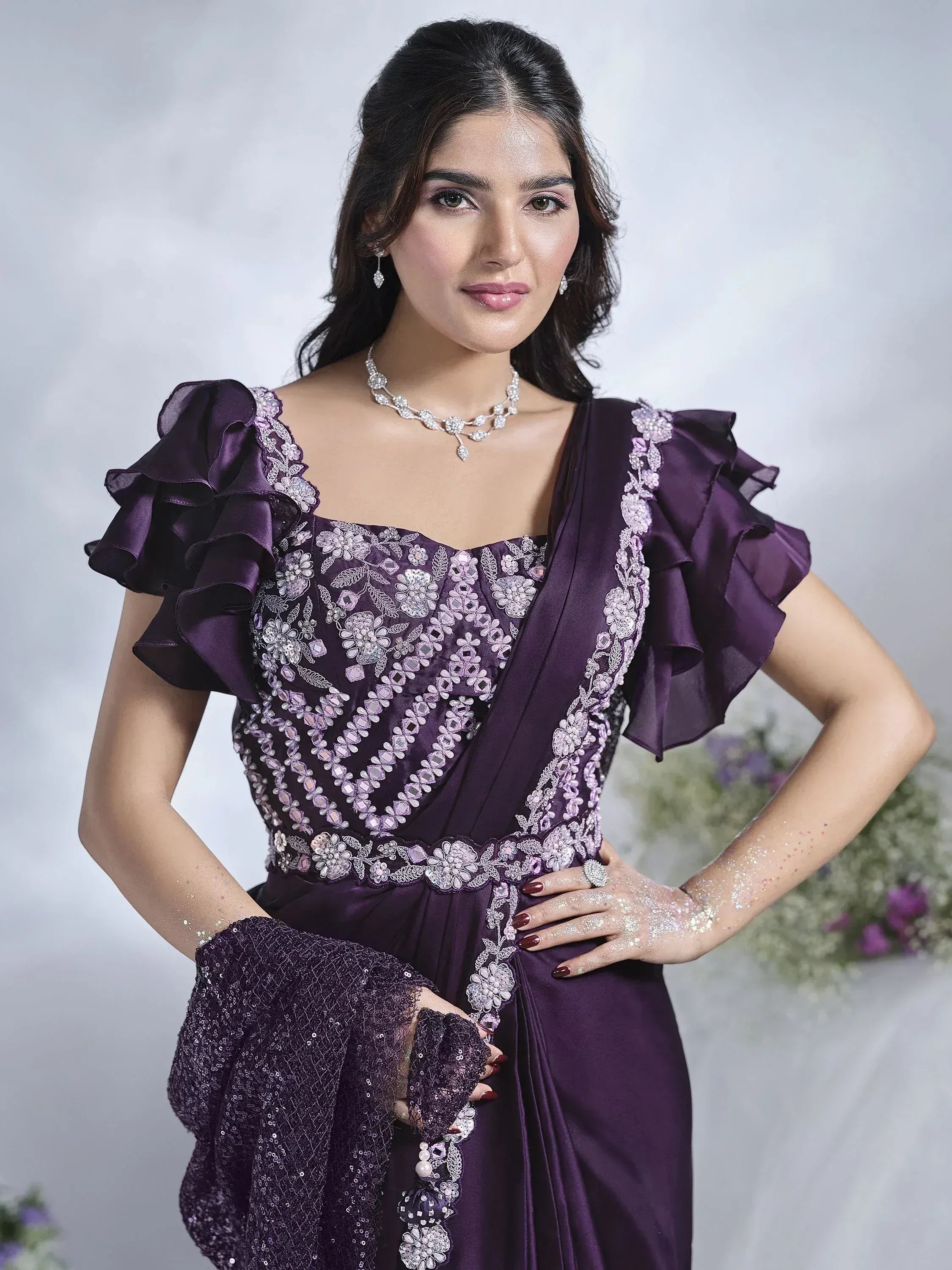 Purple ethnic gown with floral embroidery, ruffle sleeves, and sequin dupatta for Indian occasions