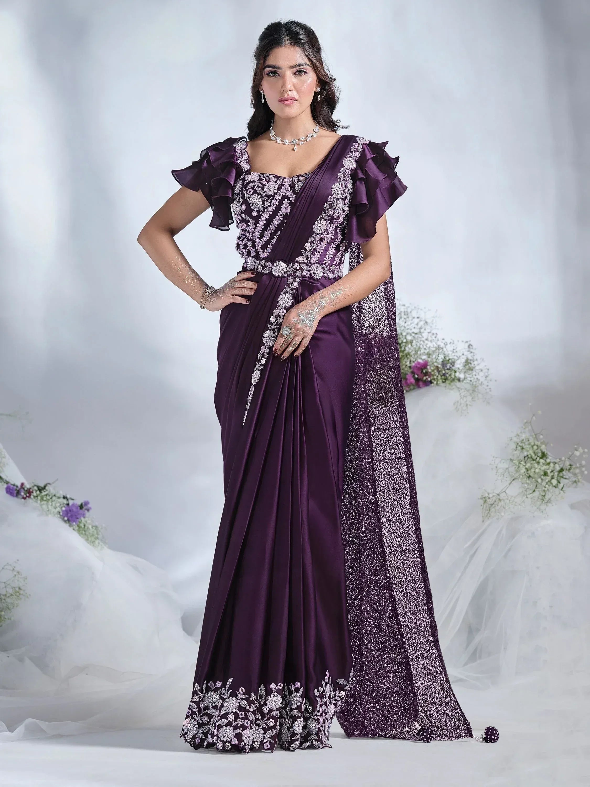 Elegant purple saree with floral embroidery, ruffle sleeves, and sequin border for Indian ethnic wear