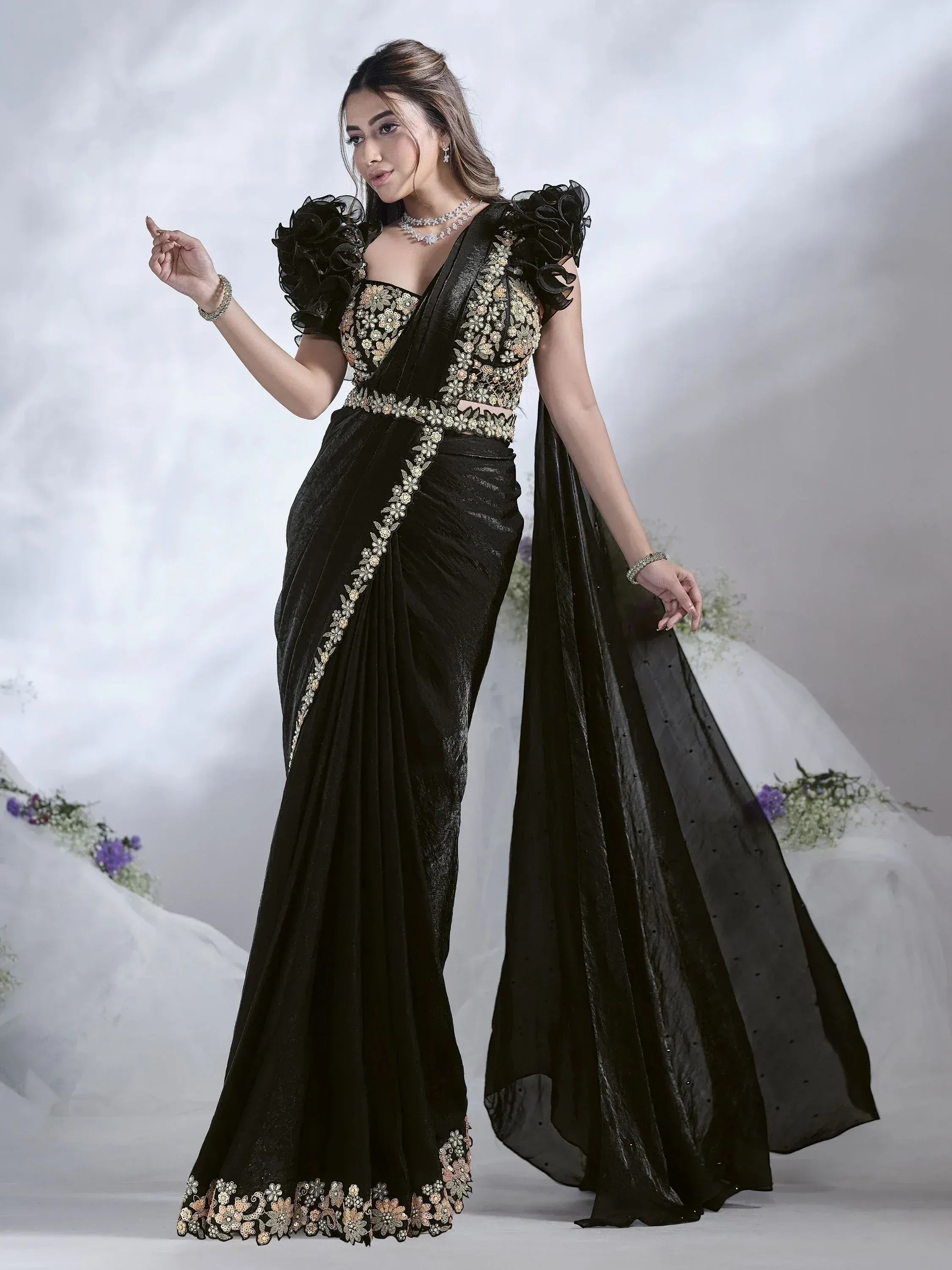 Black velvet saree with floral embroidery and ruffled sleeves, perfect for Indian ethnic wear occasions.