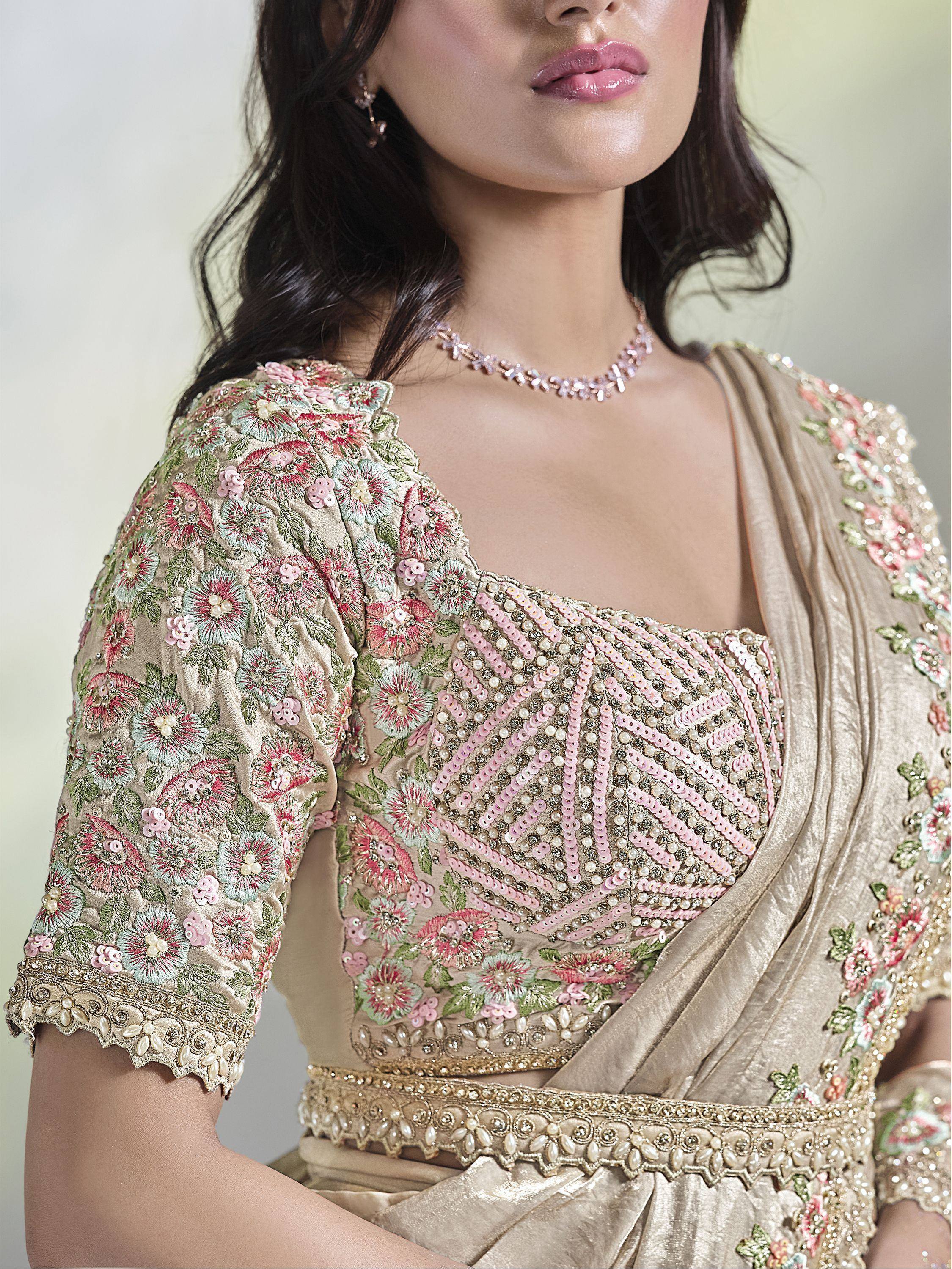 Elegant beige lehenga choli with floral embroidery and pink sequin detailing, perfect for Indian ethnic wear.