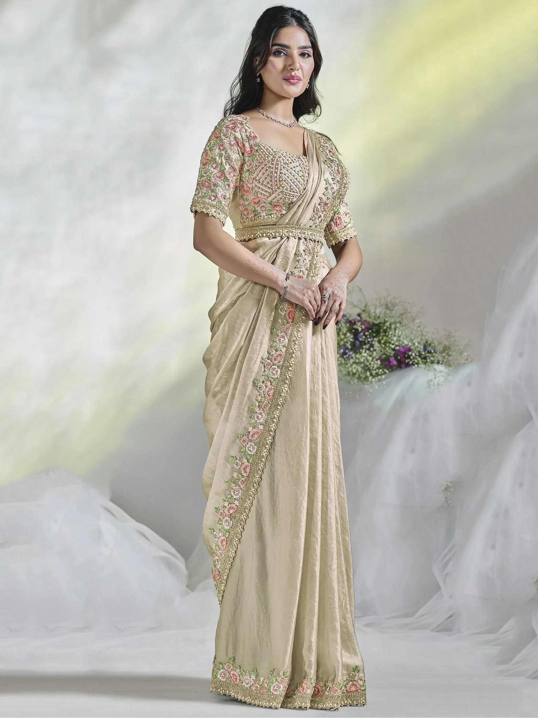 Elegant beige saree with floral embroidery and gold detailing, perfect for Indian ethnic occasions