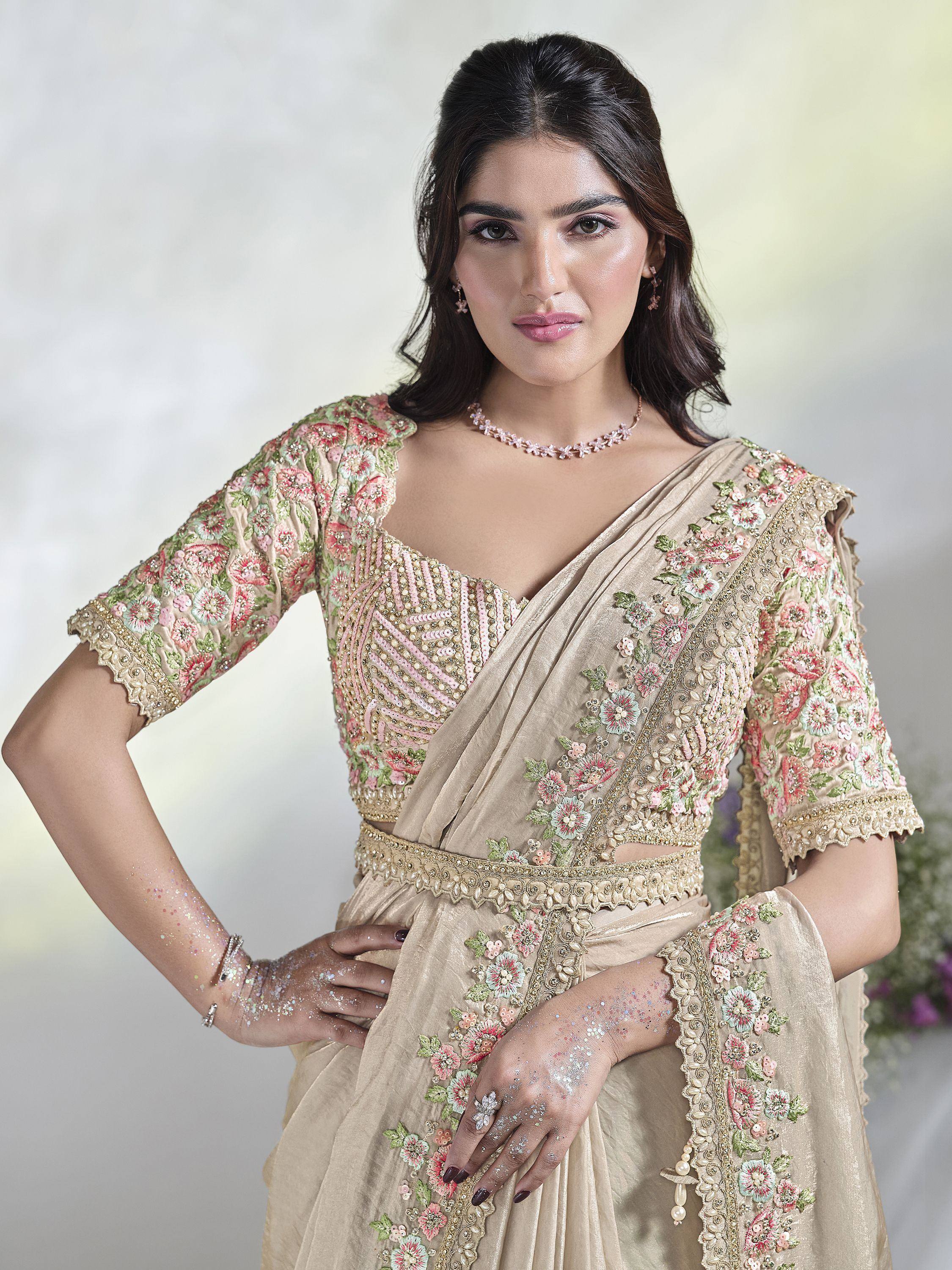 Beige floral embroidered saree with pink and green details, perfect for Indian ethnic wear occasions.