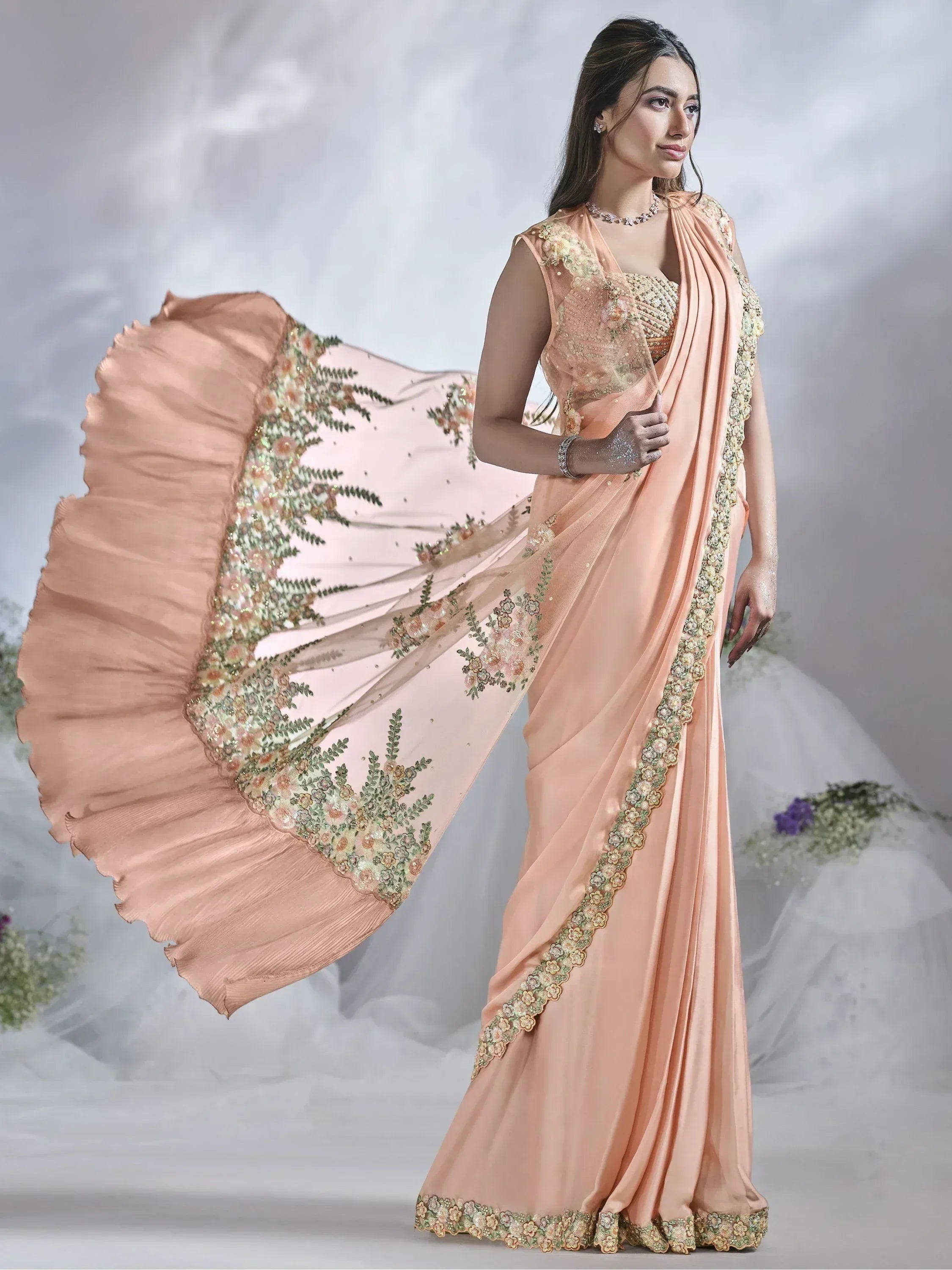 Elegant peach saree with floral embroidery and sequin work, perfect for Indian ethnic occasions.