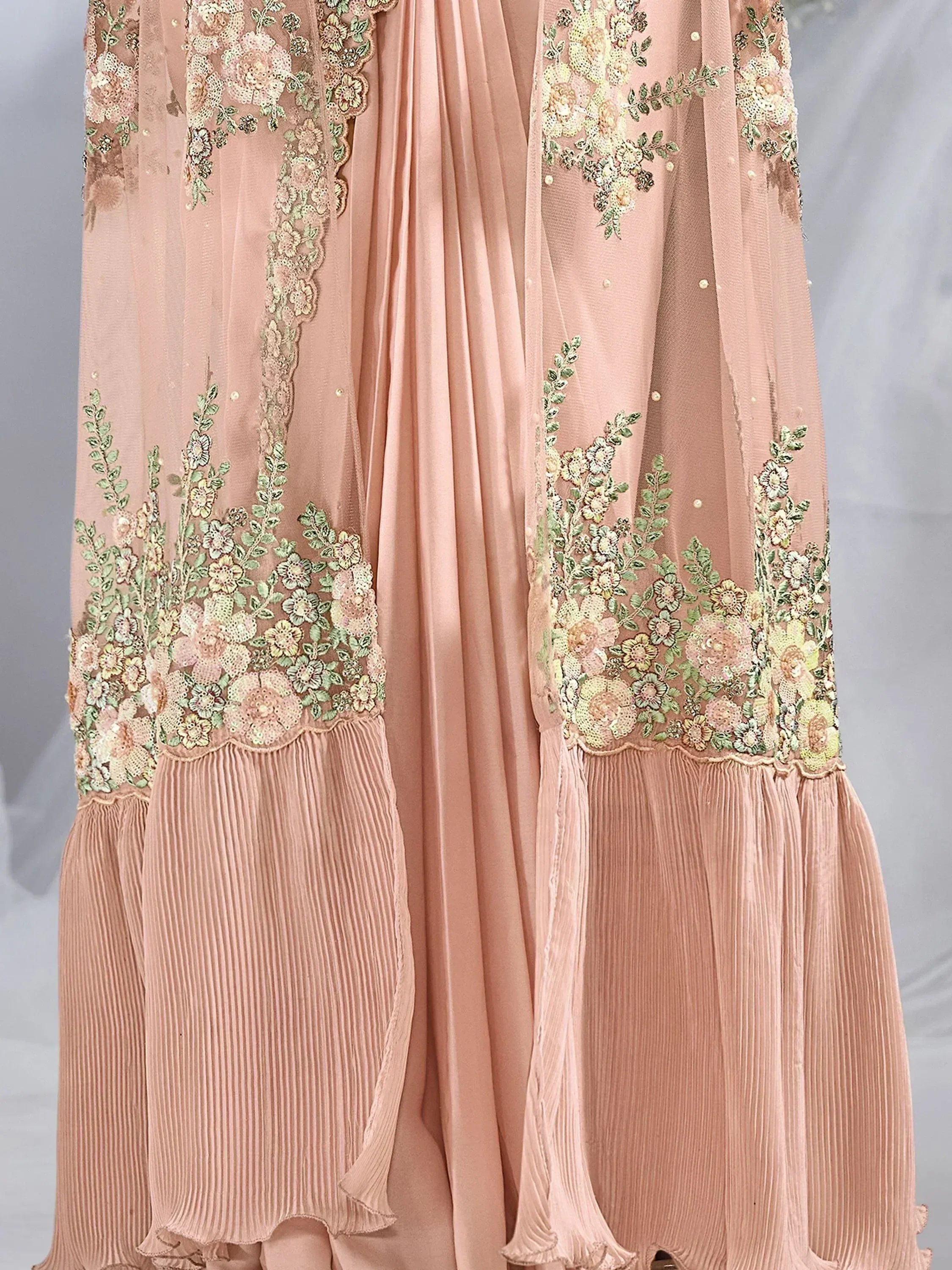 Pink ethnic gown with floral embroidery and pleated skirt, perfect for Indian weddings or festive occasions.