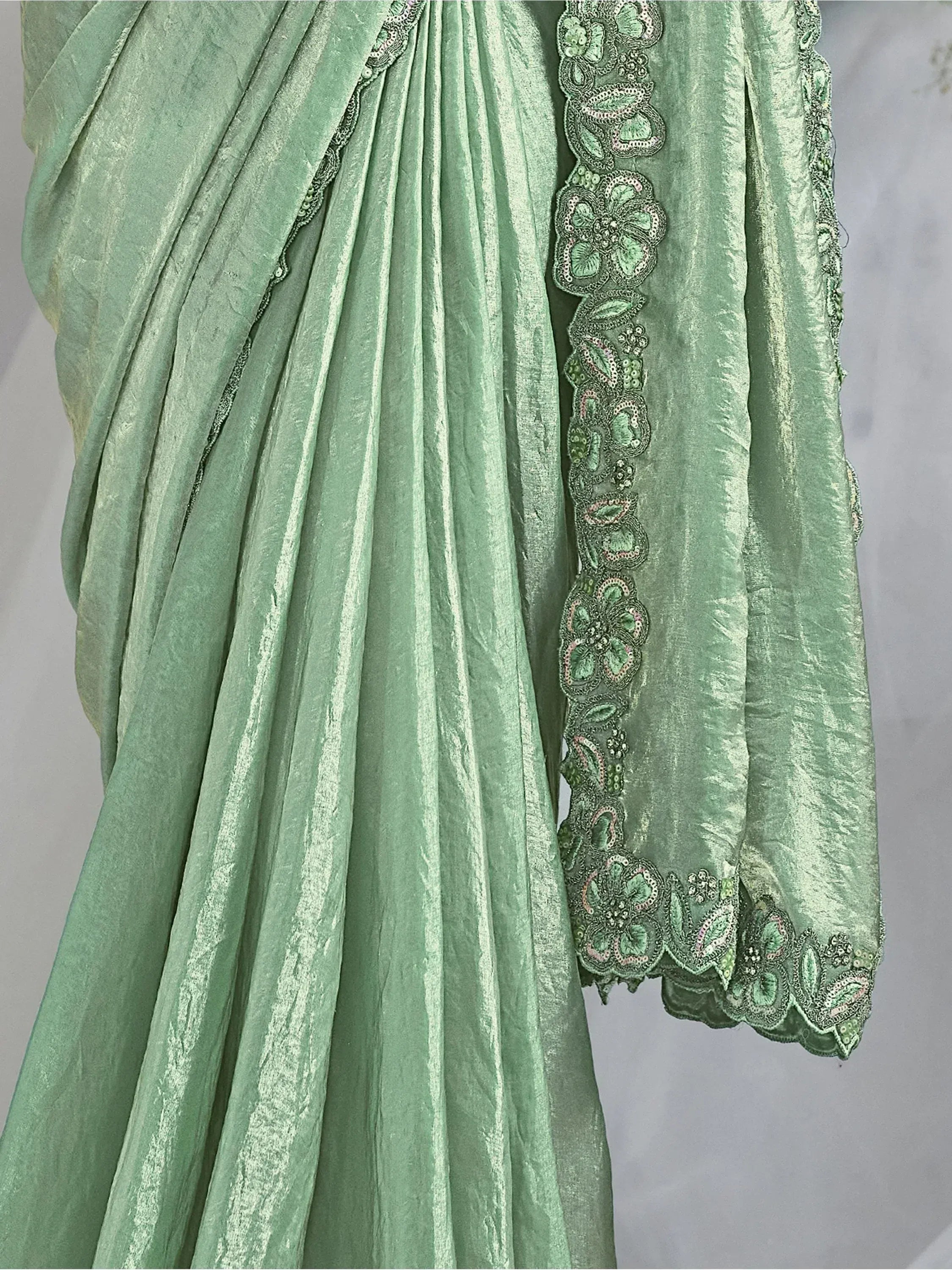Mint green velvet ethnic gown with floral embroidery and scalloped hem, perfect for Indian occasions.