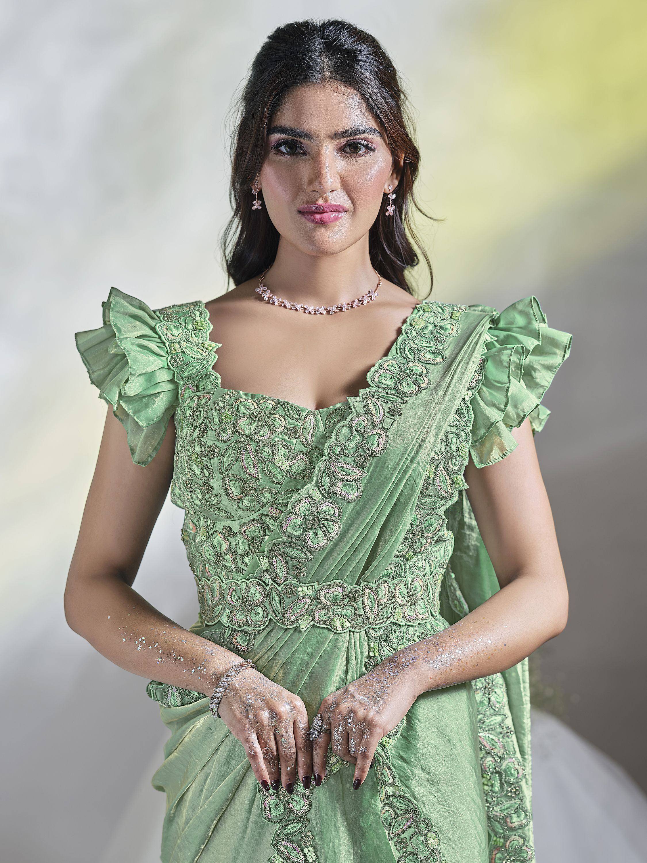 Elegant green designer gown with ruffle sleeves and floral embroidery for Indian ethnic wear