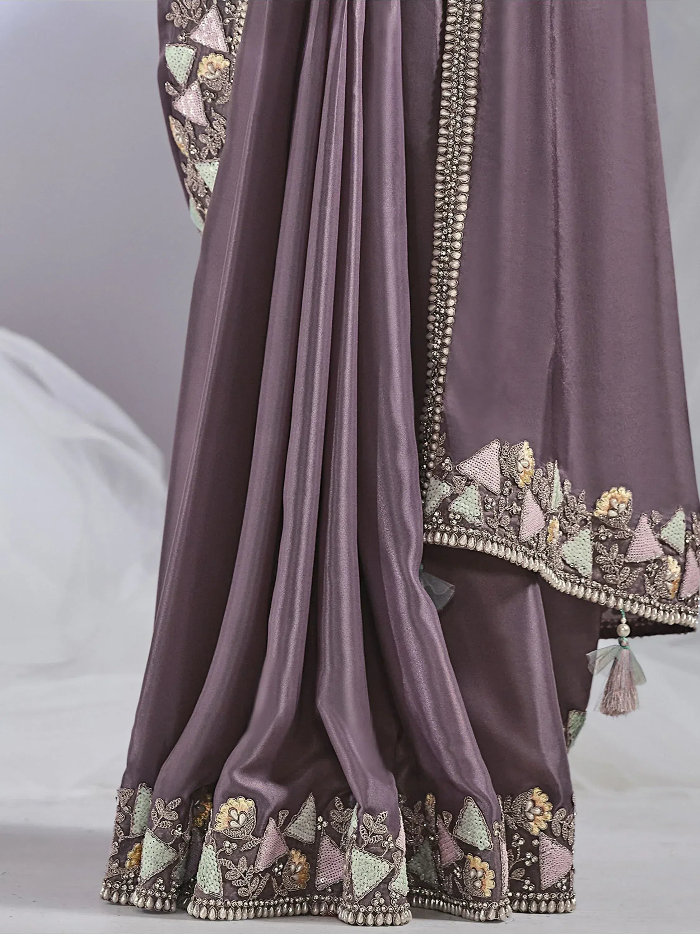 Elegant purple ethnic gown with intricate floral embroidery and beadwork detailing