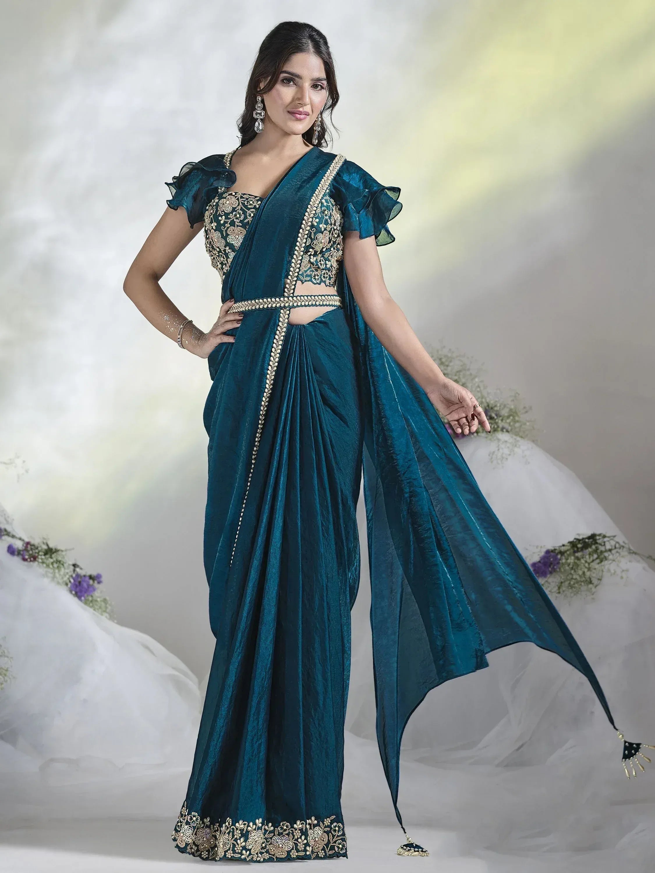 Teal blue designer saree with gold embroidery, ruffle sleeves, and embellished border for Indian ethnic wear